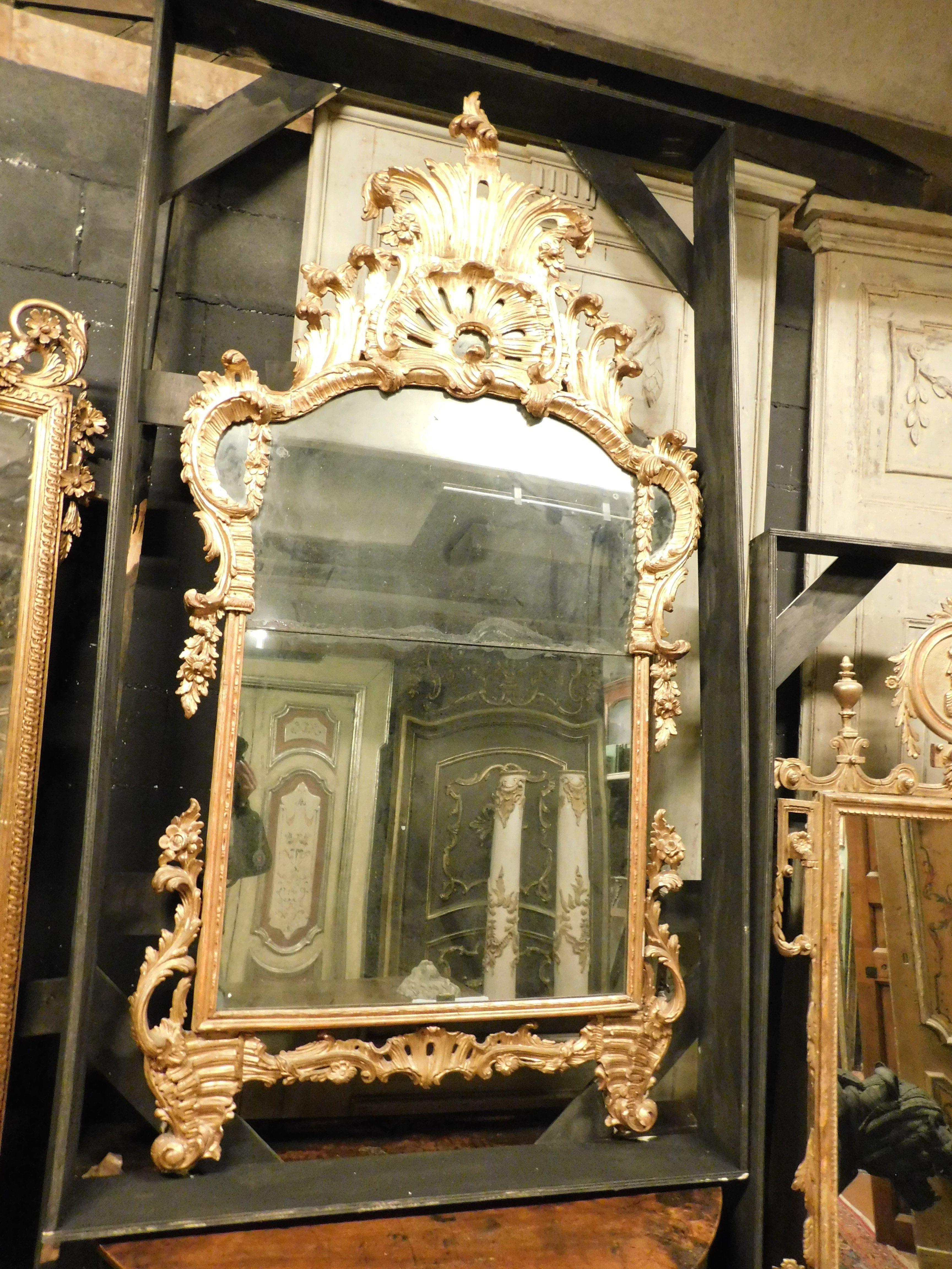 Italian Ancient gilded wooden mirror with richly carved cymatium, Italy For Sale