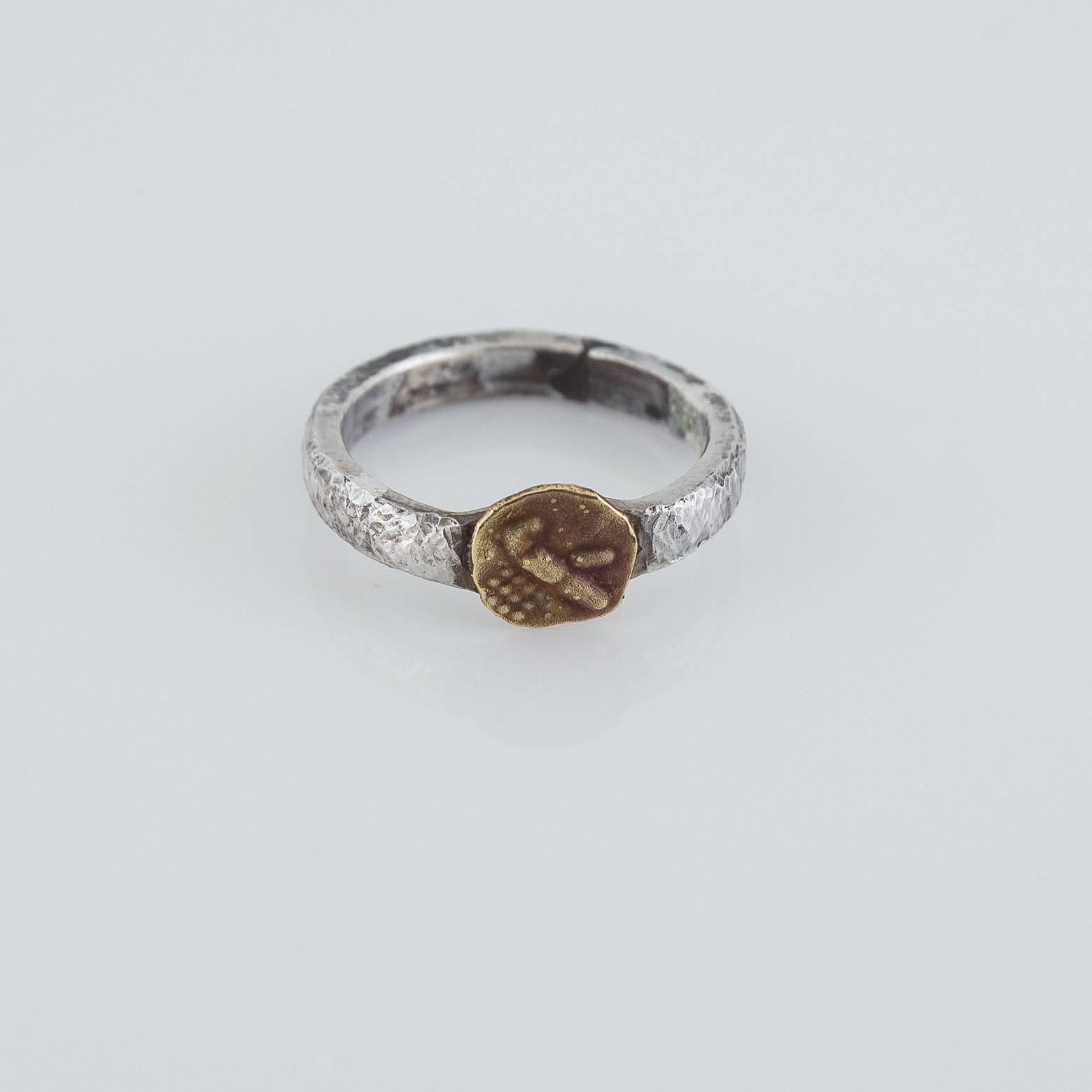 Handmade in our San Francisco Bay Area Studio this sterling silver band is hammered to create a unique almost woven texture with a stamped 14k yellow gold coin to sit on top. Fit for either sex and is a great stacking ring for added flare. This ring