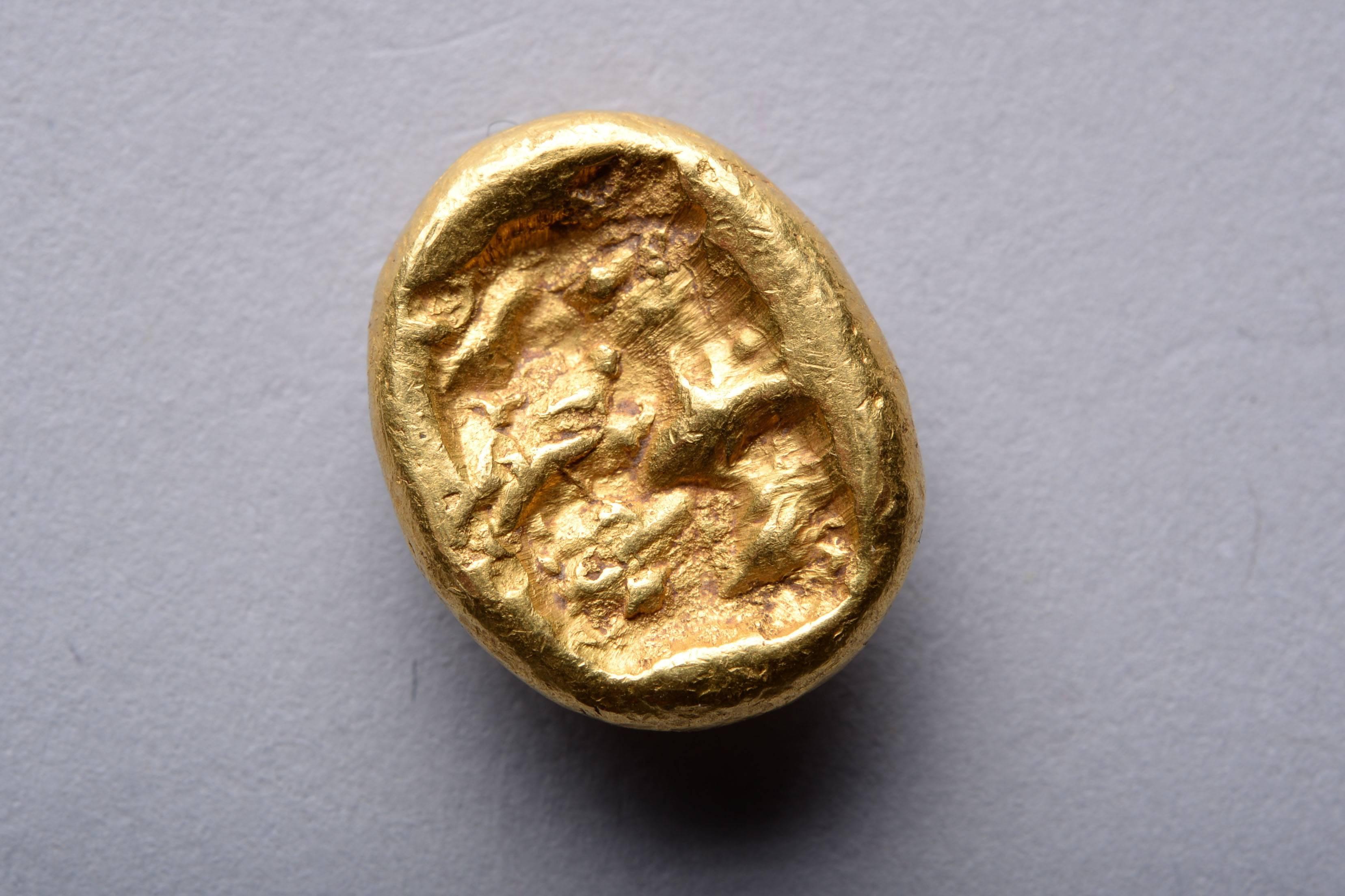 A gold daric from the Achaemenid Empire, struck at the Sardes mint sometime between the reins of Xerxes II to Artaxeres II, circa 420 - 375 BC. 

The obverse with the Great King of Kings running forwards, wearing a turreted crown and long flowing