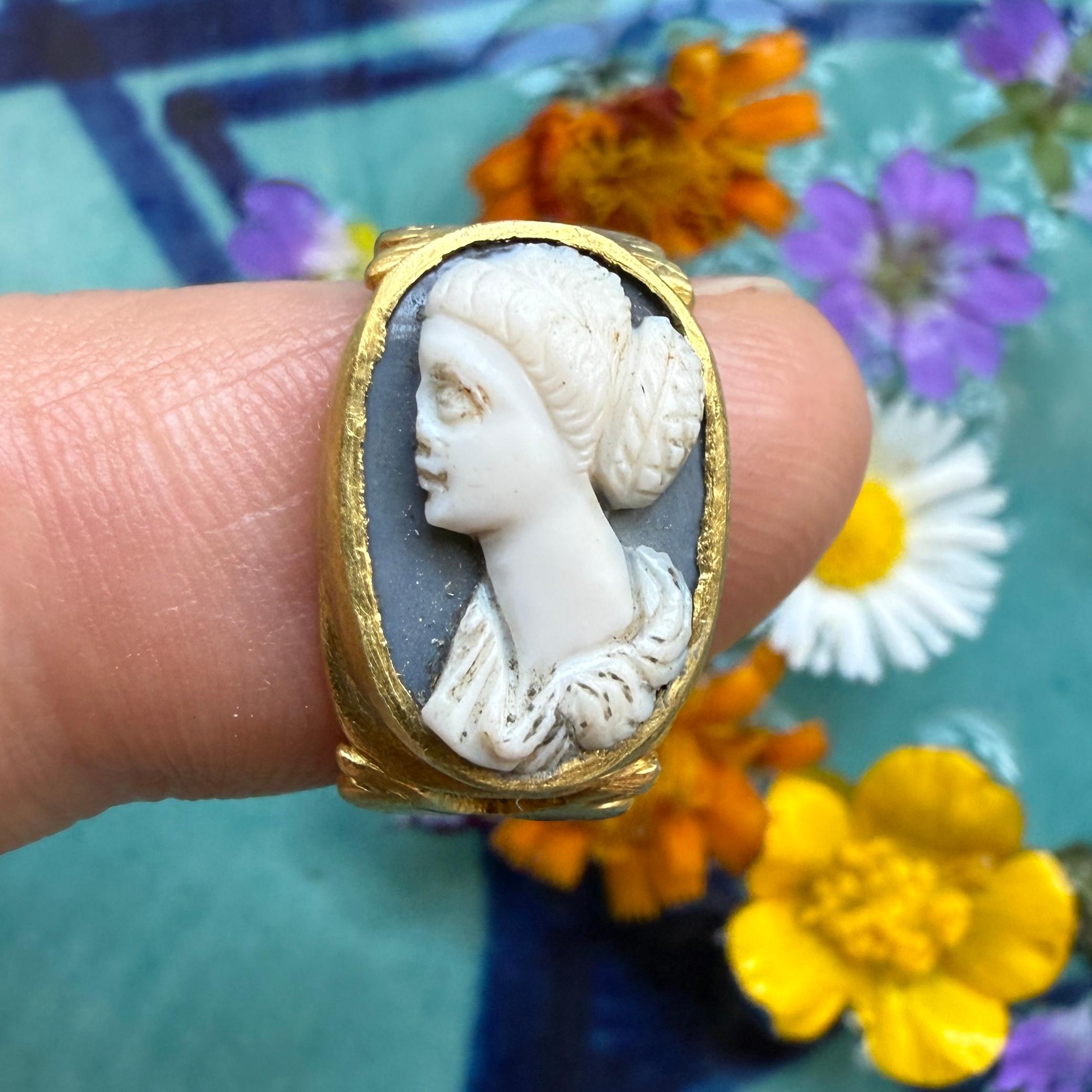 Ancient Gold Ring Set with a Sardonyx Cameo of a Woman.
 
Roman, 3rd century AD.
 
Measurements
• Ring size: F 1/2 UK / 3 US  / 44 EU 
• Bezel:  1.5 x 1.1cm
• Weight: 5.96 grams
 
A gold ring of solid construction, set with an oval sardonyx cameo