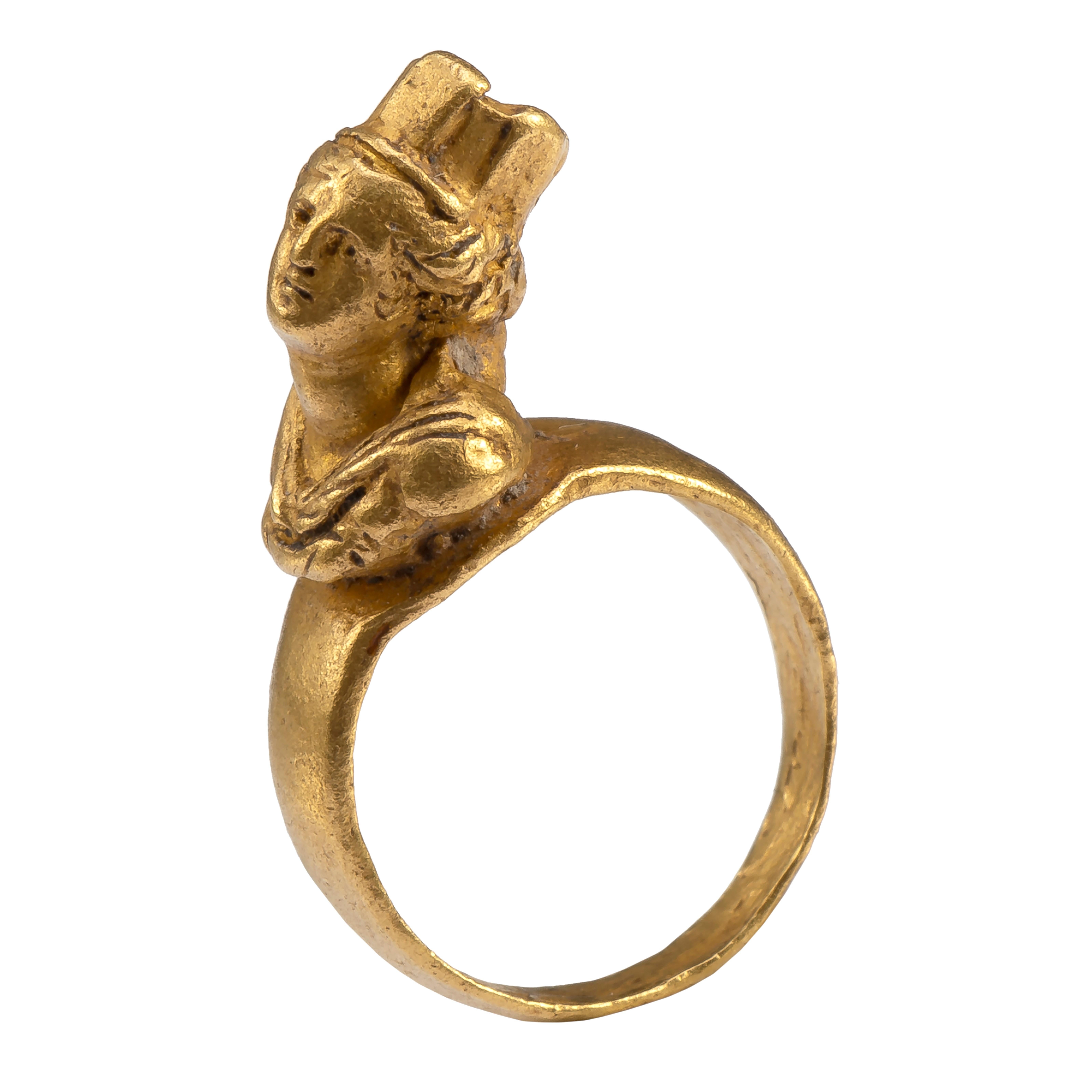 Ring with Bust of Tyche
Roman, late 1st century - 2nd Century AD
Gold
Weight 4.4 gr.; Circumference 43.45 mm.; US size 2 ¾ ; UK size E ½

Miniature sculpture in ring form of the Greek goddess of fortune and luck. This glorious ring is