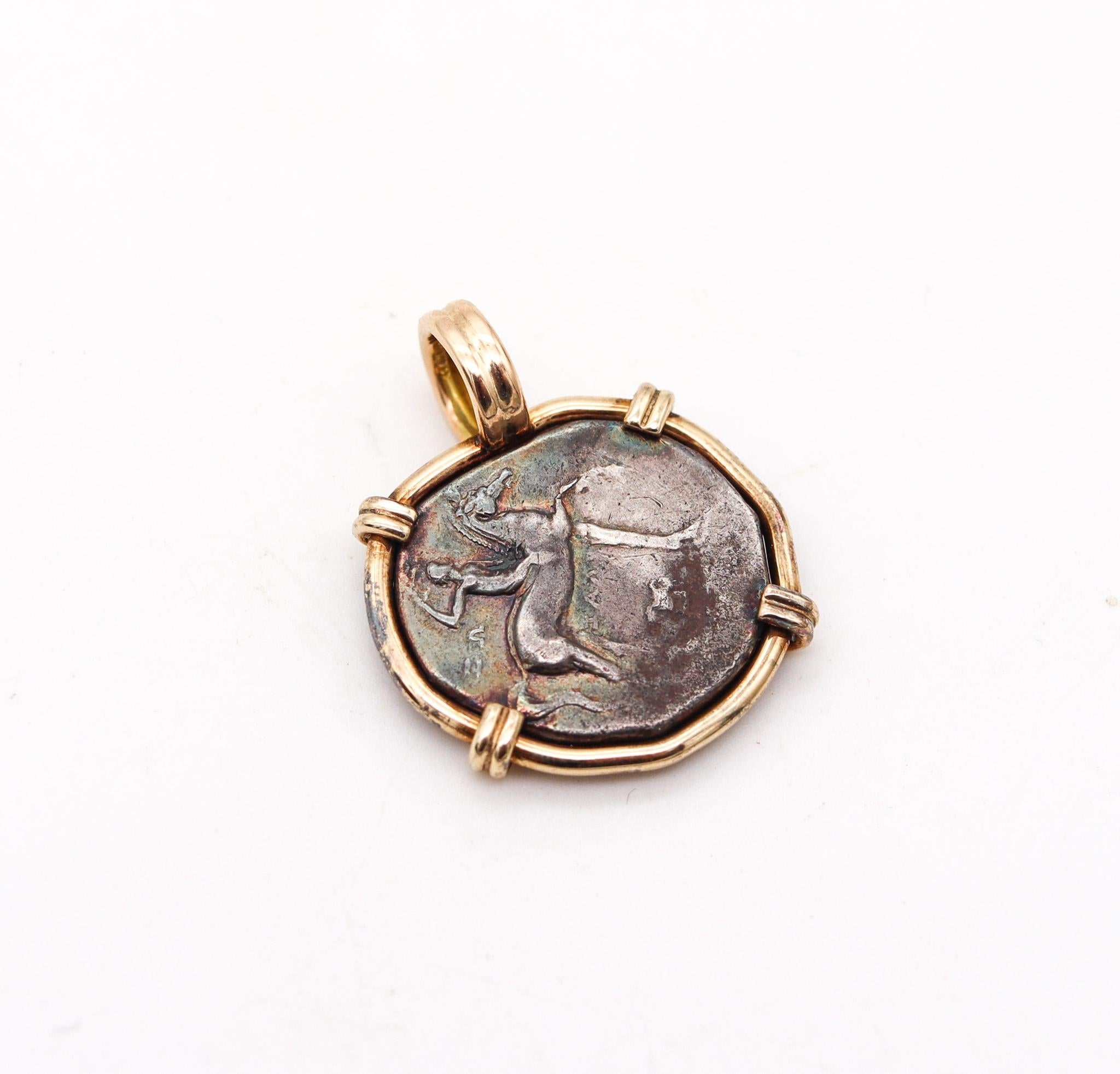 Boy riding a dolphin framed coin pendant.

An ancient silver coin of one Tarantine Stater struck between 280-240 BC in the Greek port city of Tarentum, located in Calabria in the very southern Italy. This ancient coin has been carefully mounted in a