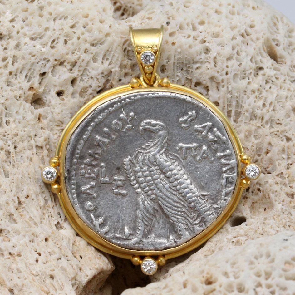 An authentic Ancient Greek silver tetradrachm from the later Ptolemaic Dynasty in Egypt is set in this ancient-inspired handmade 18K setting with four 1.8 mm VS1 diamonds as accents designed by Steven Battelle  This Hellenistic (Greek) Kingdom in