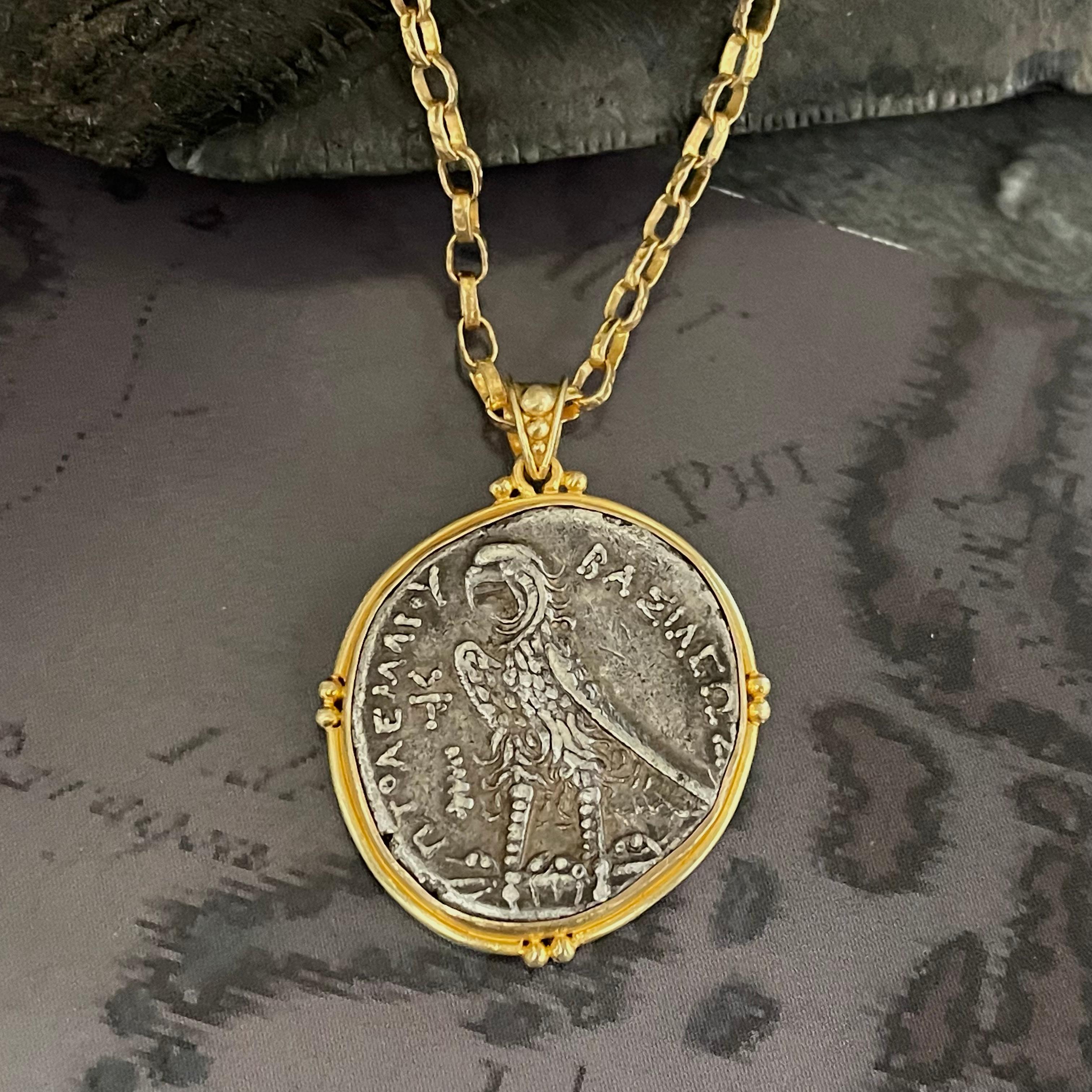 An authentic Ancient Greek coin from the Ptolemaic Dynasty in Egypt is set in this ancient-inspired handmade 18K setting designed by Steven Battelle  This Hellenistic (Greek) Kingdom in Egypt was founded in 305 BC by Ptolemy I Soter, a companion of
