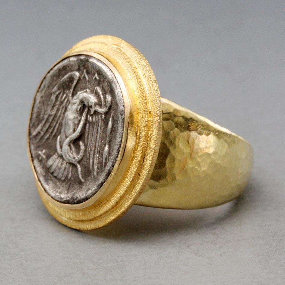 A clear and crisply struck image of an eagle carrying a snake in its talons is depicted on an authentic ancient Greek silver 