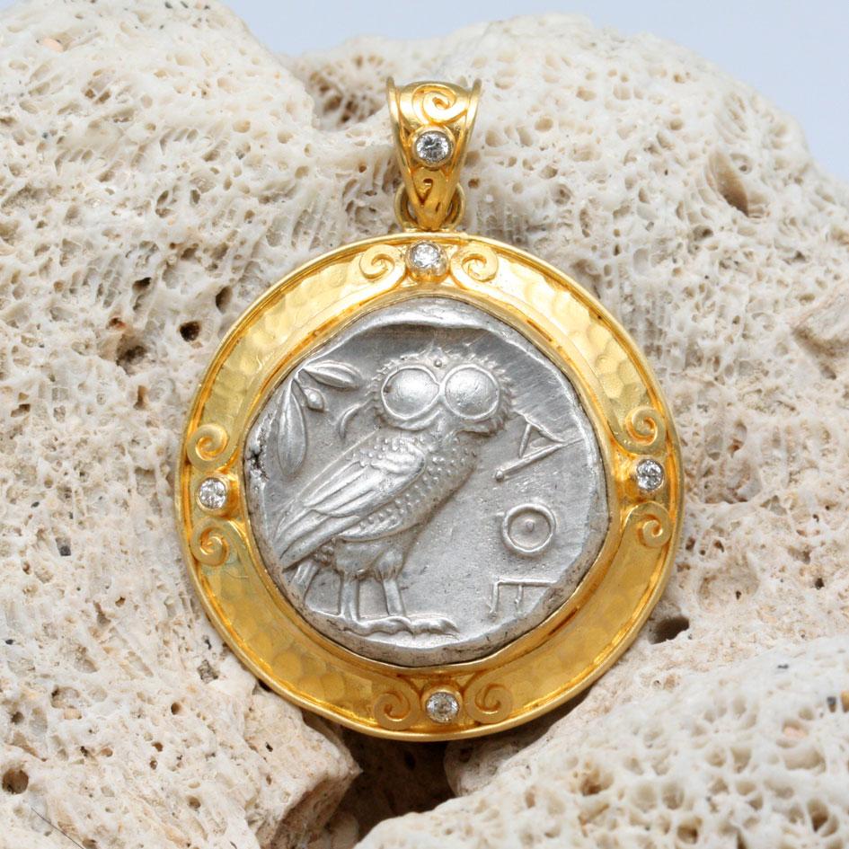 An iconic top-grade authentic ancient Greek Athenian owl coin from 475-425 BC is held in an ancient-inspired handmade 22K hammered gold setting with flat wire spirals and five 1.8 mm VS1 diamonds accents in this signature design from artist Steven