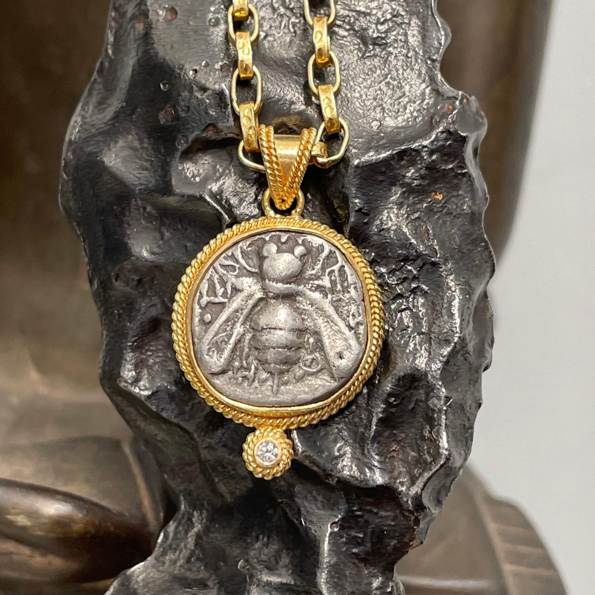 An authentic ancient early Greek coin from Ephesus is held in a double twist wire bezel with a 1.8 mm VS1 diamond accent below in this beautiful Steven Battelle designed pendant. Ephesus was an ancient Greek colony established in what is now the