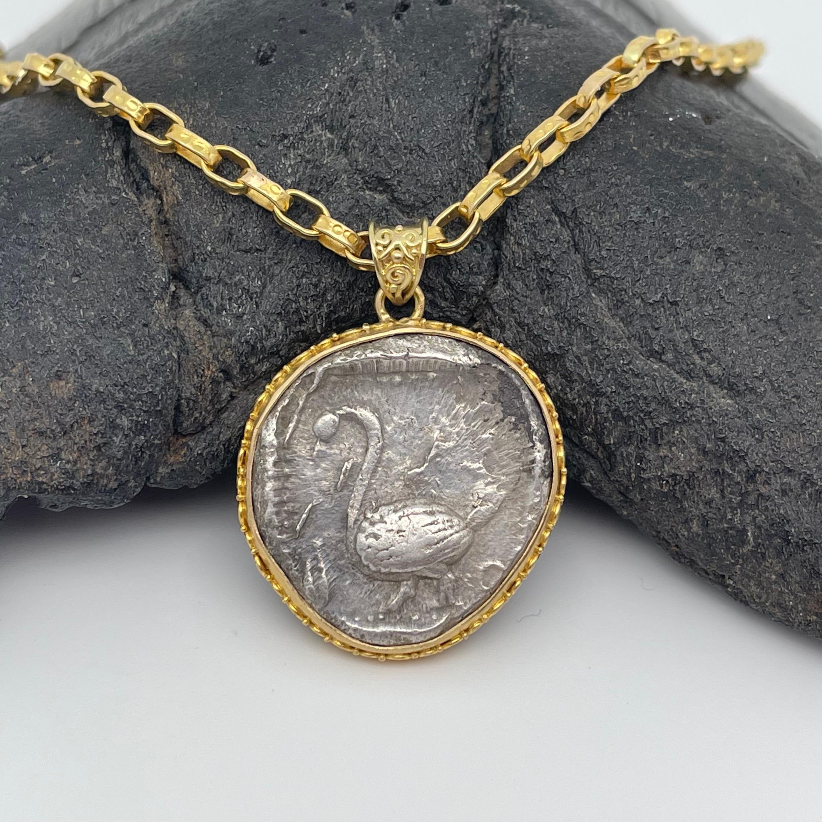 An authentic ancient Greek coin from the region of Cilicia (now in Western Turkey) with a beautiful depiction of a swan is featured in this Steven Battelle pendant design with intricate hand applied doubled spirals accenting the bezel.  This is a