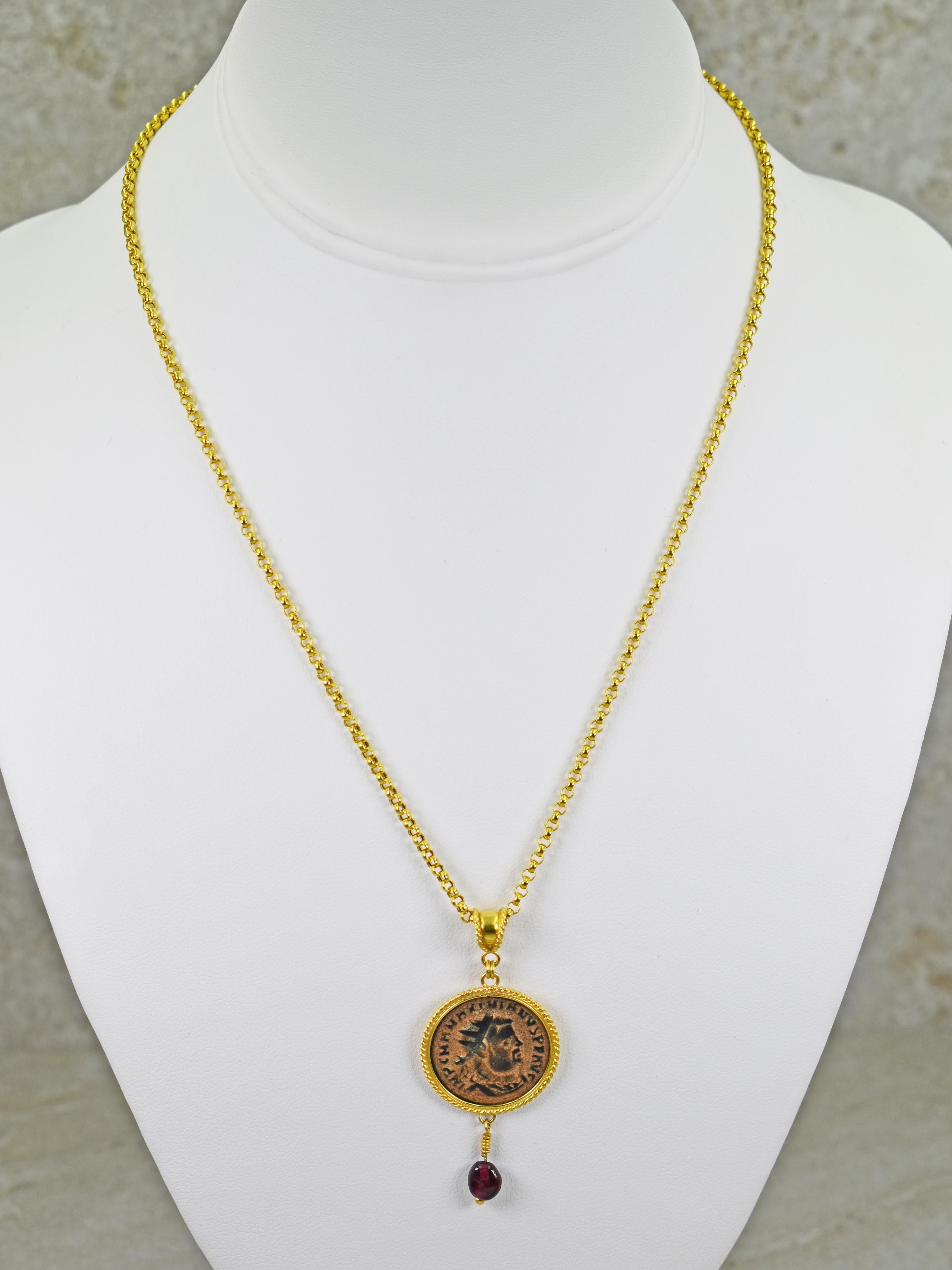 Authentic ancient Roman bronze coin and ancient Garnet bead drop 22k yellow gold pendant on a 21k gold rolo chain necklace. Rolo chain is 18 inches in length, and pendant, including bail and charm, is 2.07 inches or 53mm in length.