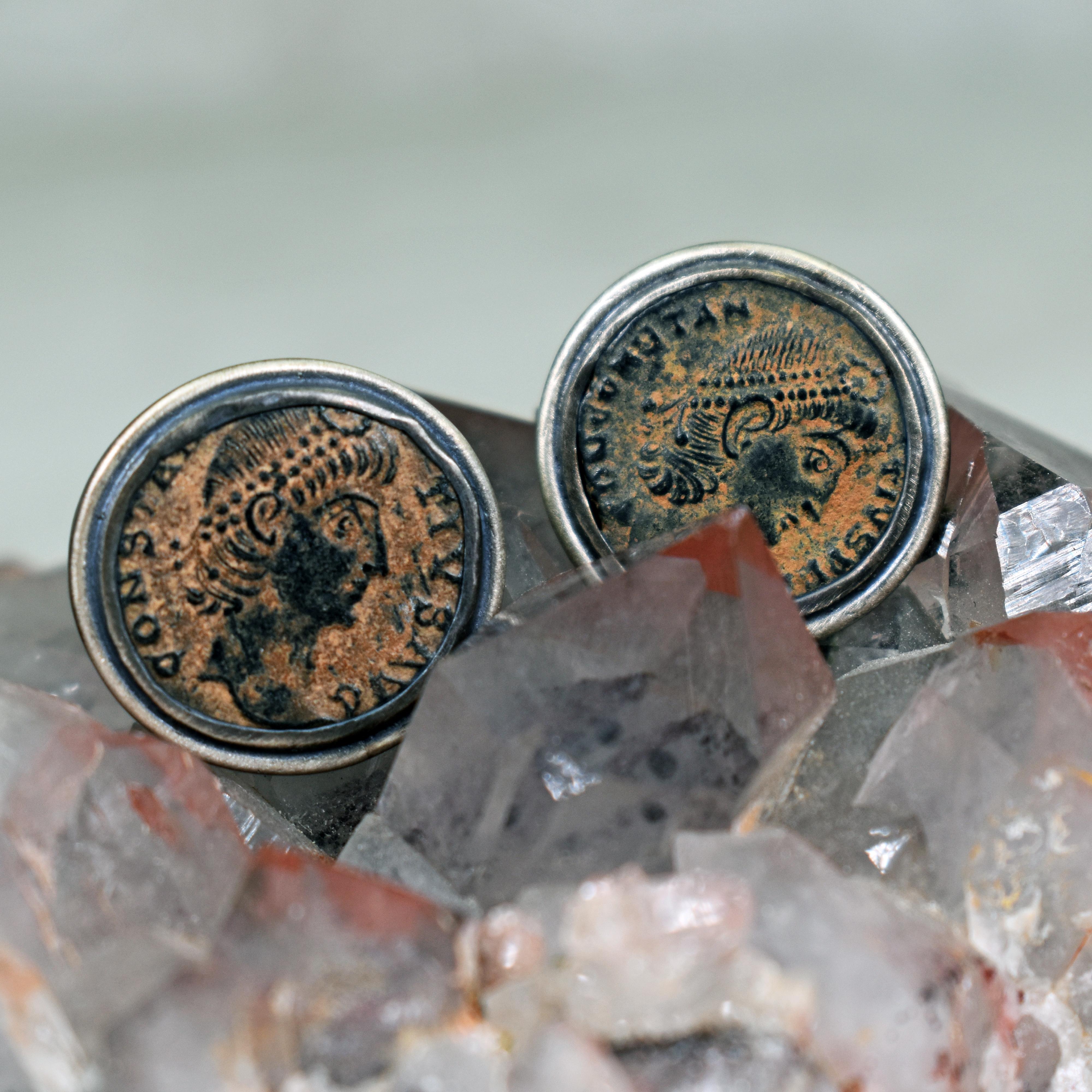 Authentic ancient Roman bronze coins set in oxidized sterling silver cuff links and finished with a brushed texture. Cuff links are approximately 0.63 inches in diameter. Stamped 925.