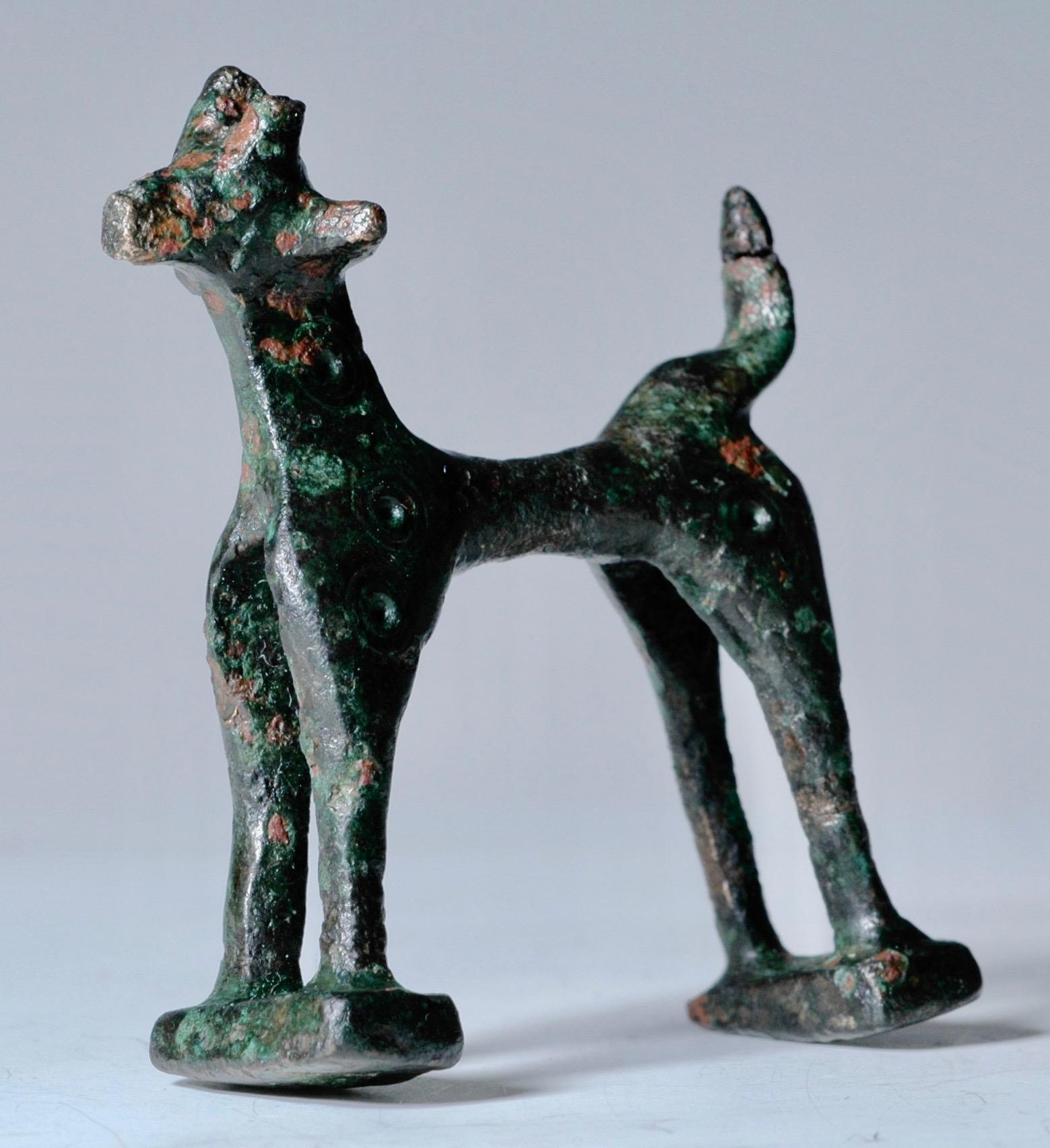 Greek bronze geometric deer decorated with concentric circles, Greece, 8th century BC. This piece was the handle of the cover of a round bronze box called Pyxis. Deer are rare in comparison to horses that where more common. These bronze geometric