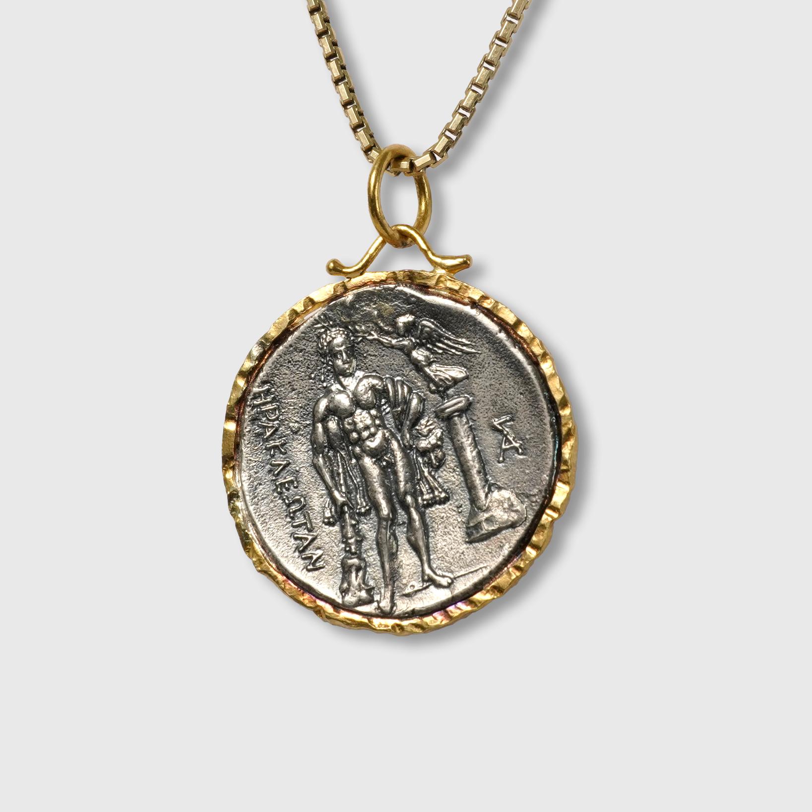 24kt gold and sterling silver pendant of an Ancient Greek Coin (Replica) with Head Wreath & Wheat and 0.07cts Diamonds.  Sterling Silver coin is a replica coin from those in the Turkish Museum. 

Back of coin shows greek man, angel and greek