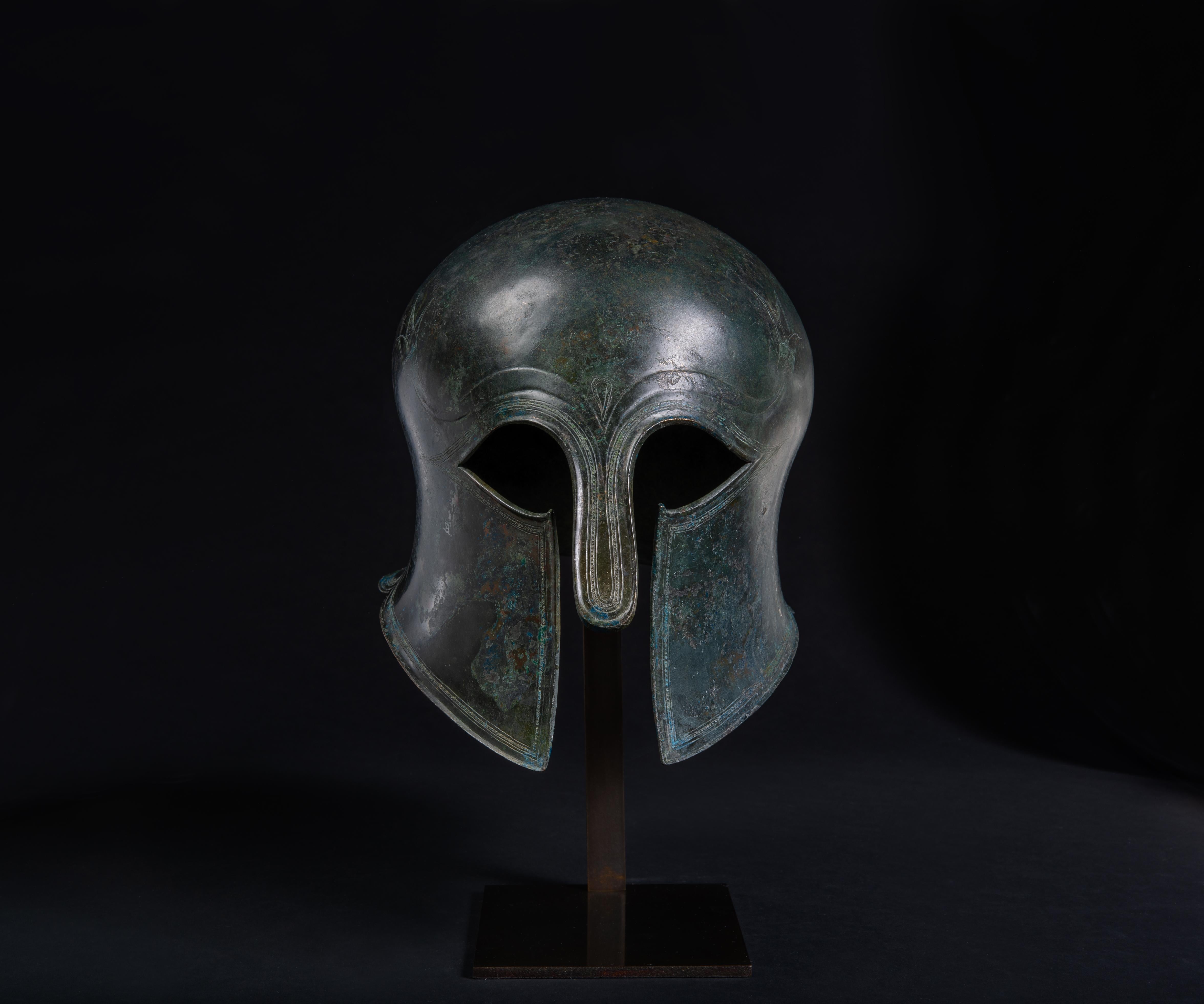 Corinthian helmet with Bull Horns and Lotus Flower Decoration.
Archaic Period, c.550-500 BC.
Cast, hammered and incised bronze.

An exceptionally well preserved example of one of the most iconic ancient Greek artefacts. This is the finest and best