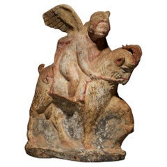 Ancient Greek Eros riding a goat in terracotta