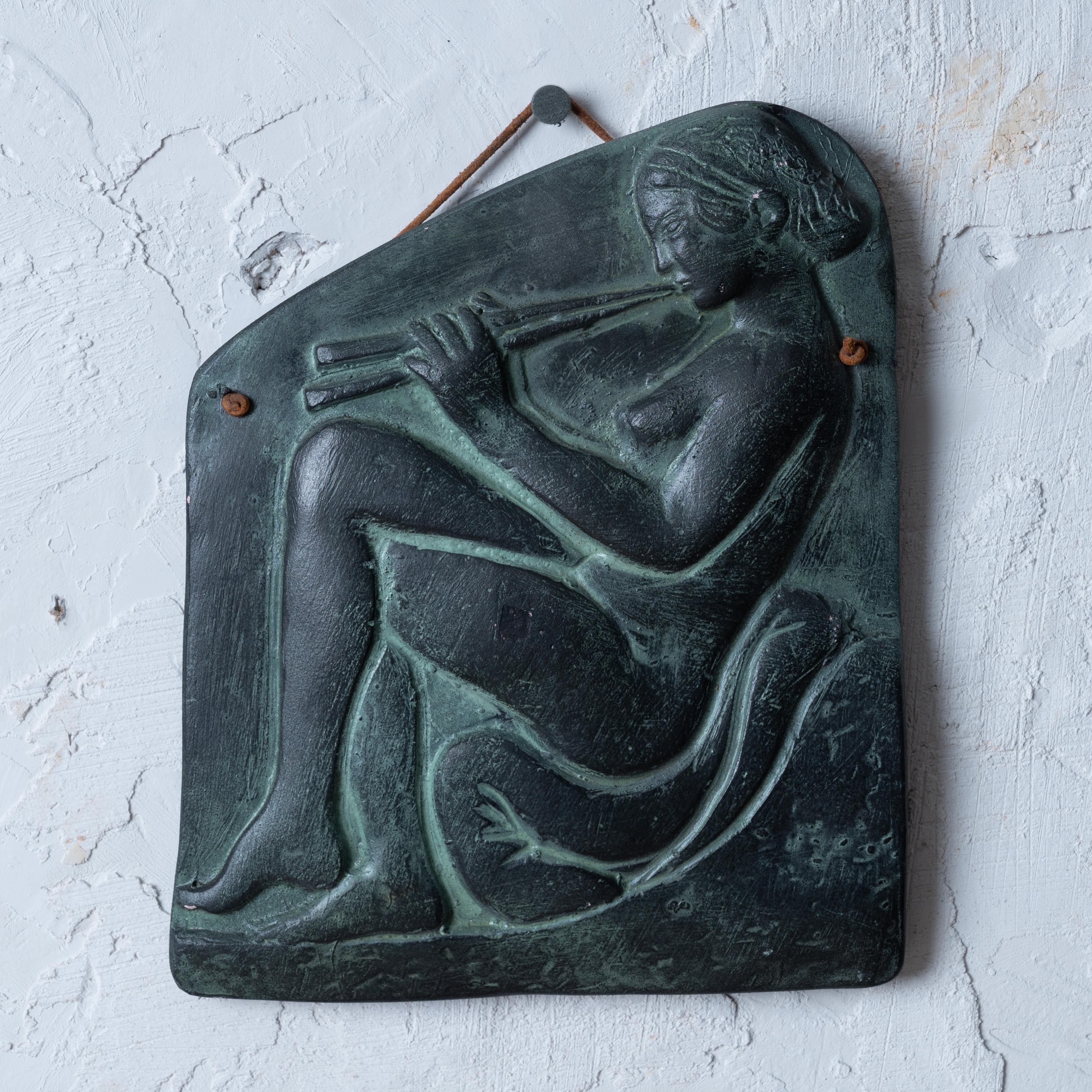 Ein Souvenir-Gipsrelief aus patinierter Bronze, das eine Figur aus dem 5. Jahrhundert v. Chr. darstellt. Relief eines griechischen Flötenspielers, 1960er Jahre



6 ¾ Zoll breit, 8 Zoll hoch und ¾ Zoll tief



