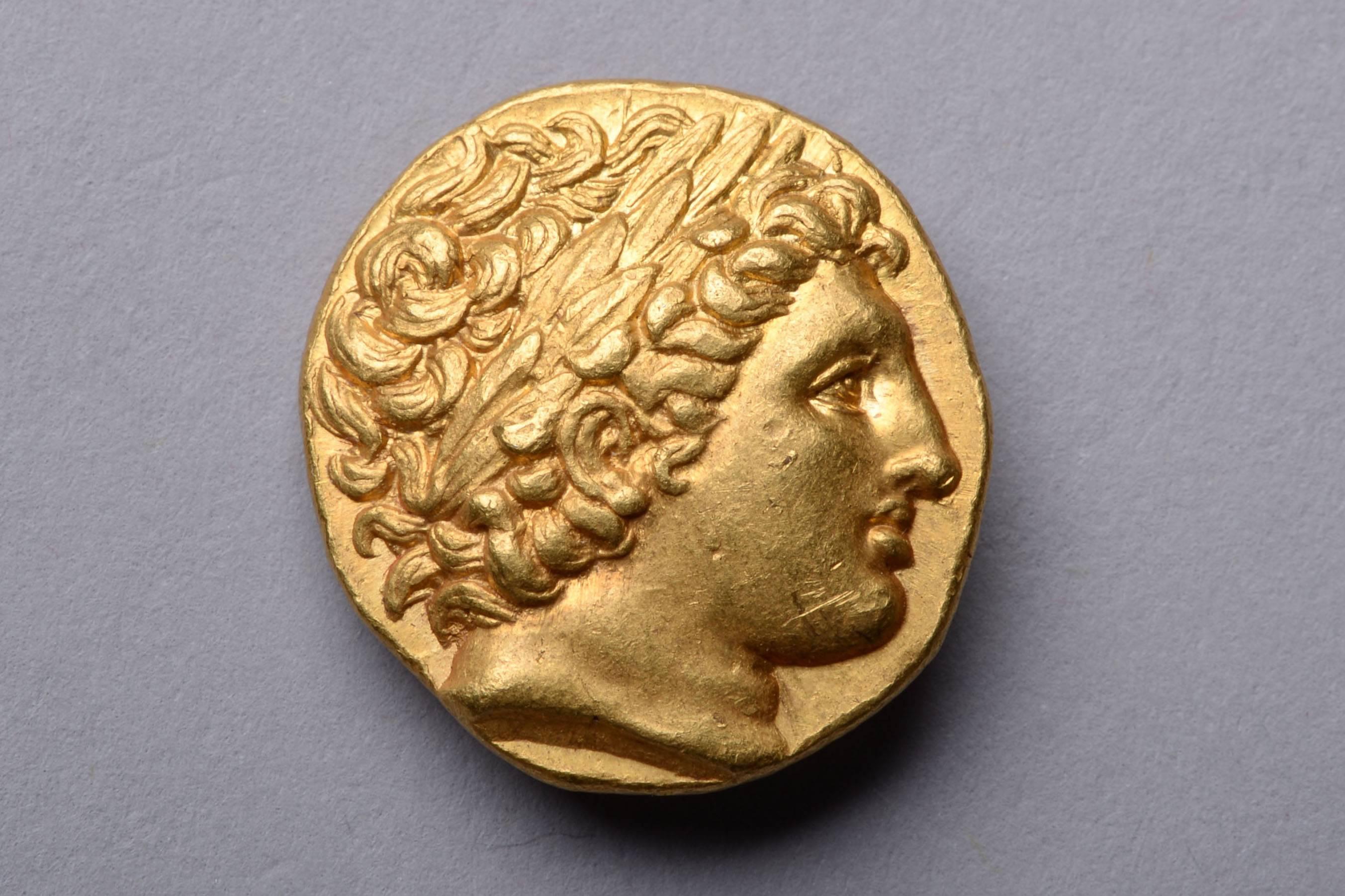 An ancient Greek gold stater, deeply struck from dies of the finest style. Minted in the name of the brilliant King Philip II of Macedon. Issued, circa 323-317 BC, at the Lampsacus mint.

The obverse with a youthful portrait of the god Apollo,