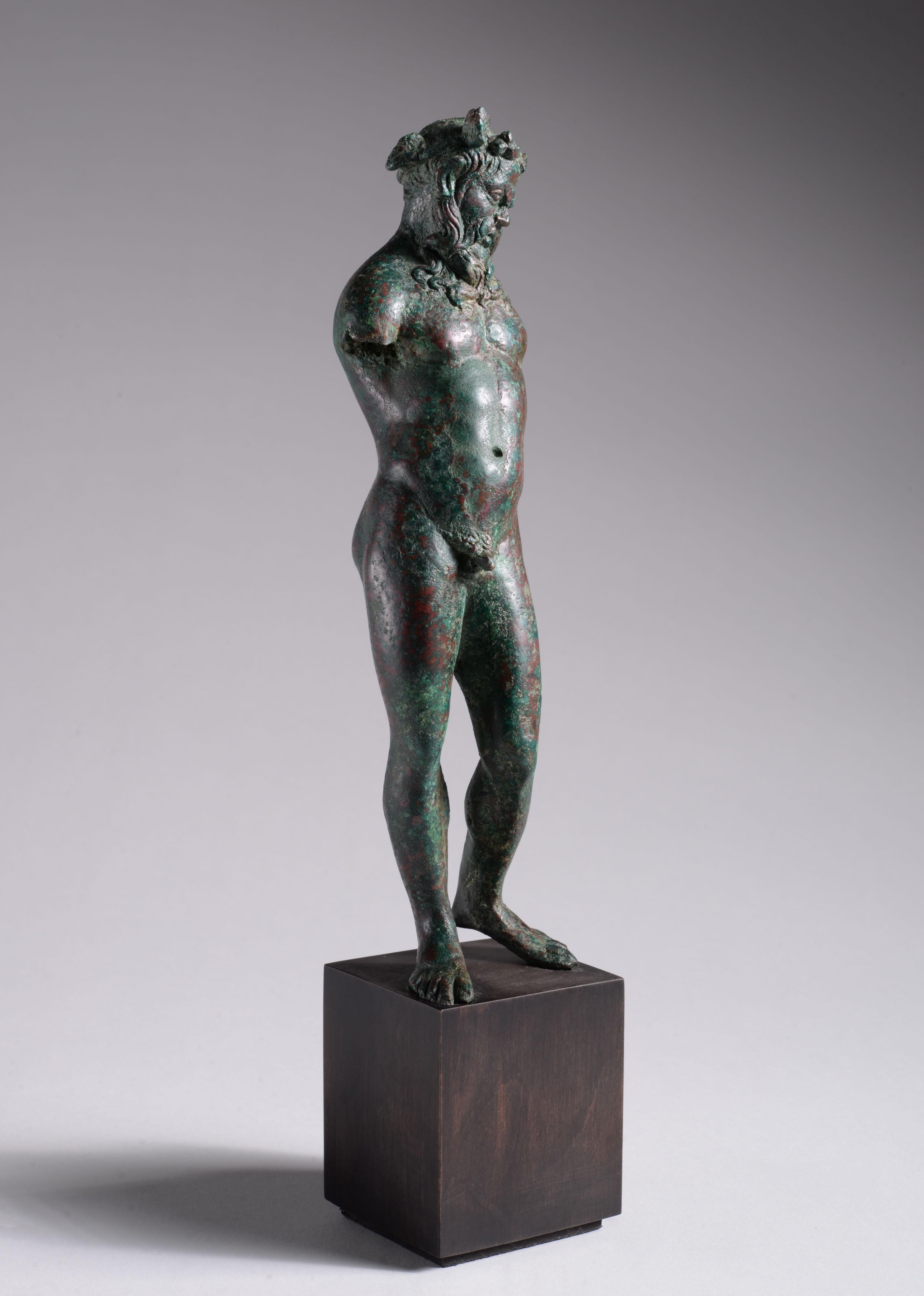 Beautifully cast statuette of a satyr, Greek, Hellenistic Period, 3rd-2nd Century BC, solid cast bronze

The present work is a wonderful example of the finest Hellenistic style. The satyr stands in contrapposto, with his weight on the right leg, the