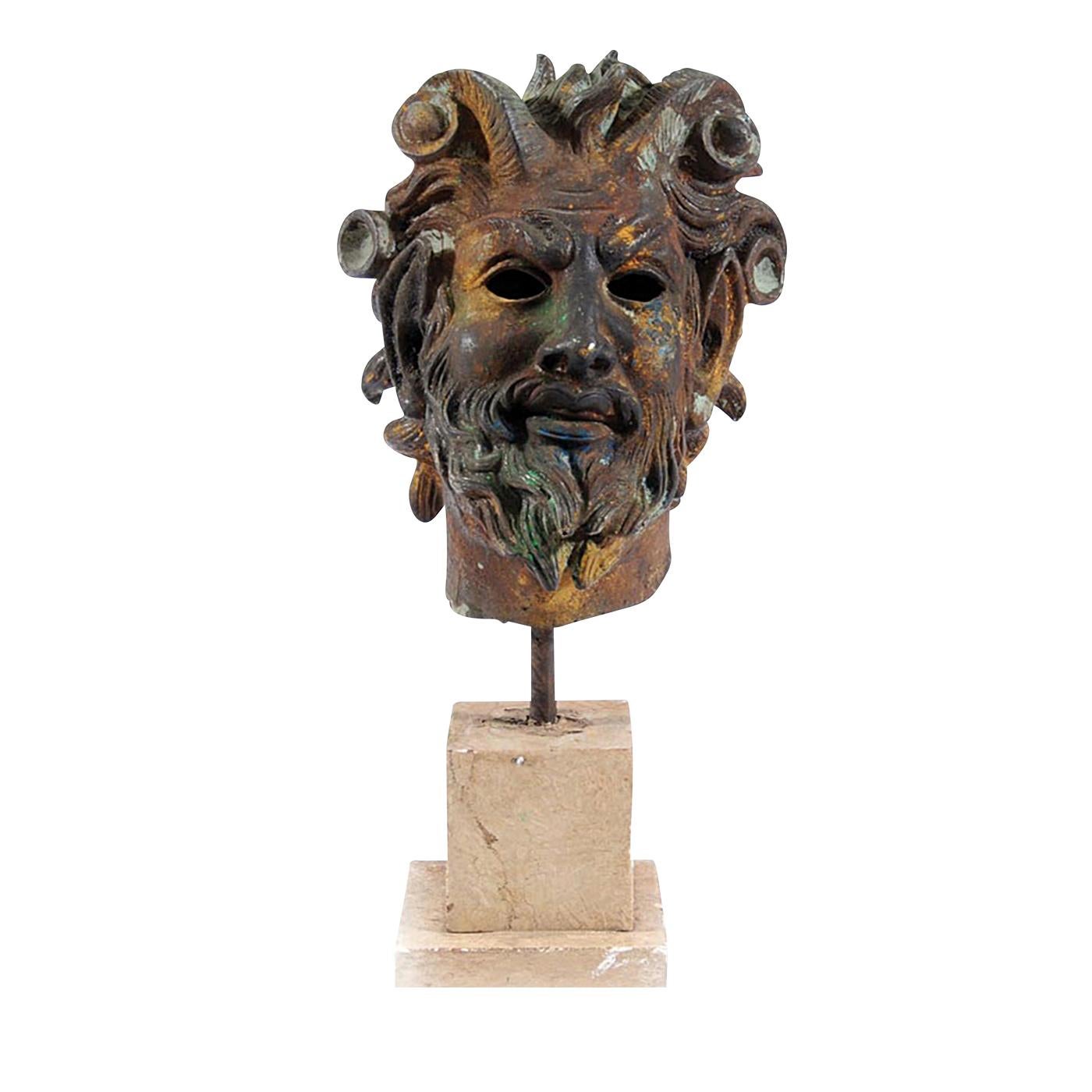 This exquisite piece represents the head of a bearded faun, clearly depicted with his goat horns and elongated ears. The faun was the Roman equivalent of the ancient Greek satyr, a mythological half human-half goat creature, manifestation of forest