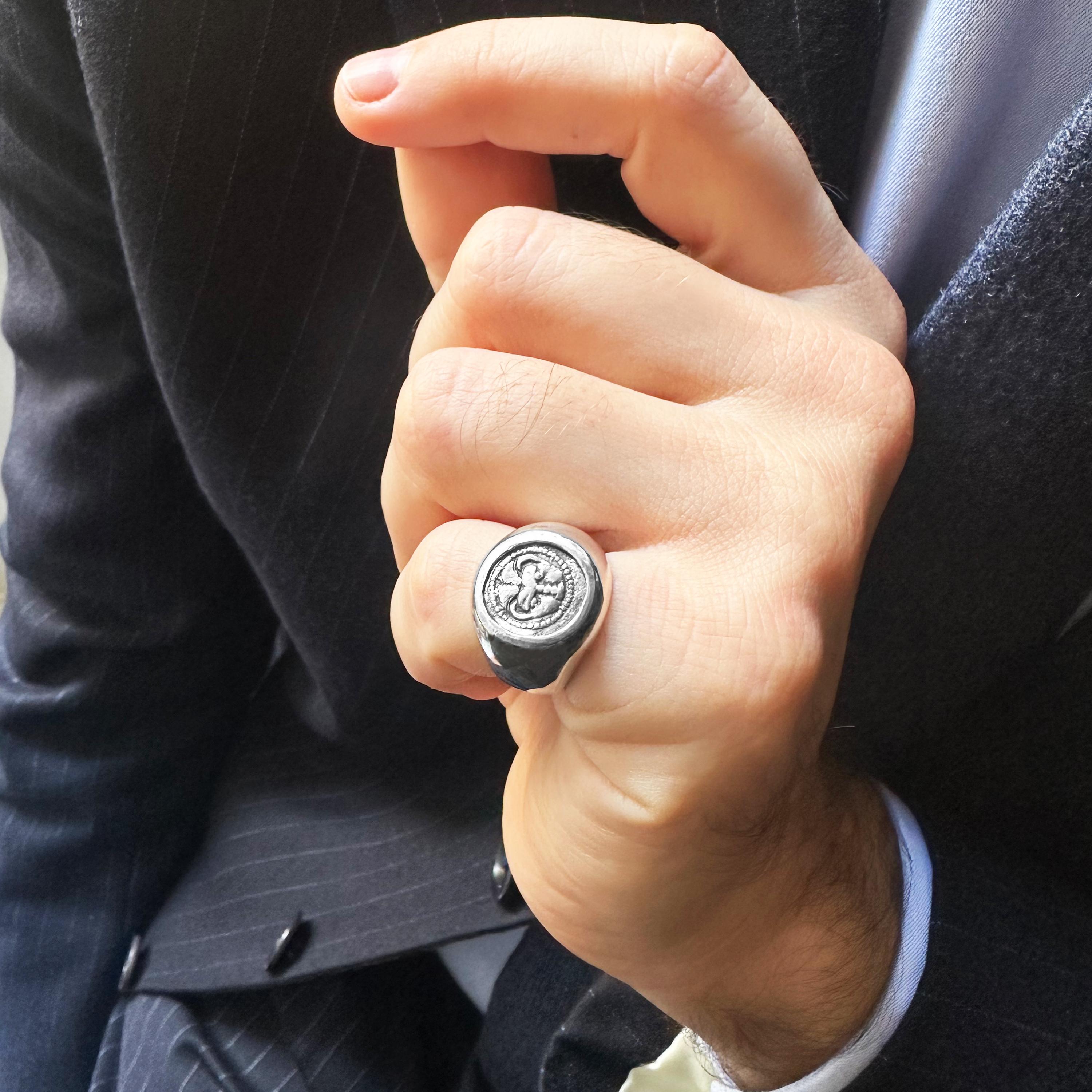 This sterling silver ring holds within it an ancient relic—a genuine coin hailing from Magna Graecia, specifically from the 5th century BC Bruttium, nestled in the region of Calabria. The coin bears the visage of a lion's head on one side and on the