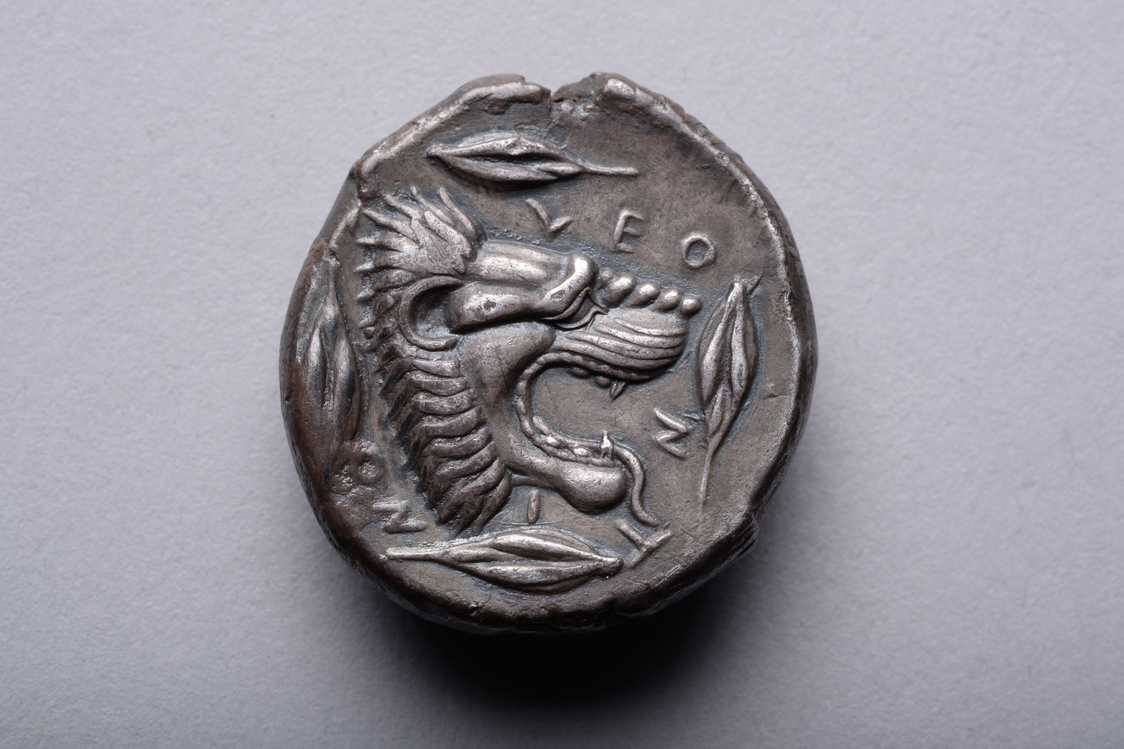 Silver tetradrachm from Leontini, Sicily, circa 450 BC.

The obverse with Apollo, patron deity of Leontini. The god is shown wearing a laurel wreath, his long hair tied into a chignon at the nape of the neck, with loose curls cascading down his