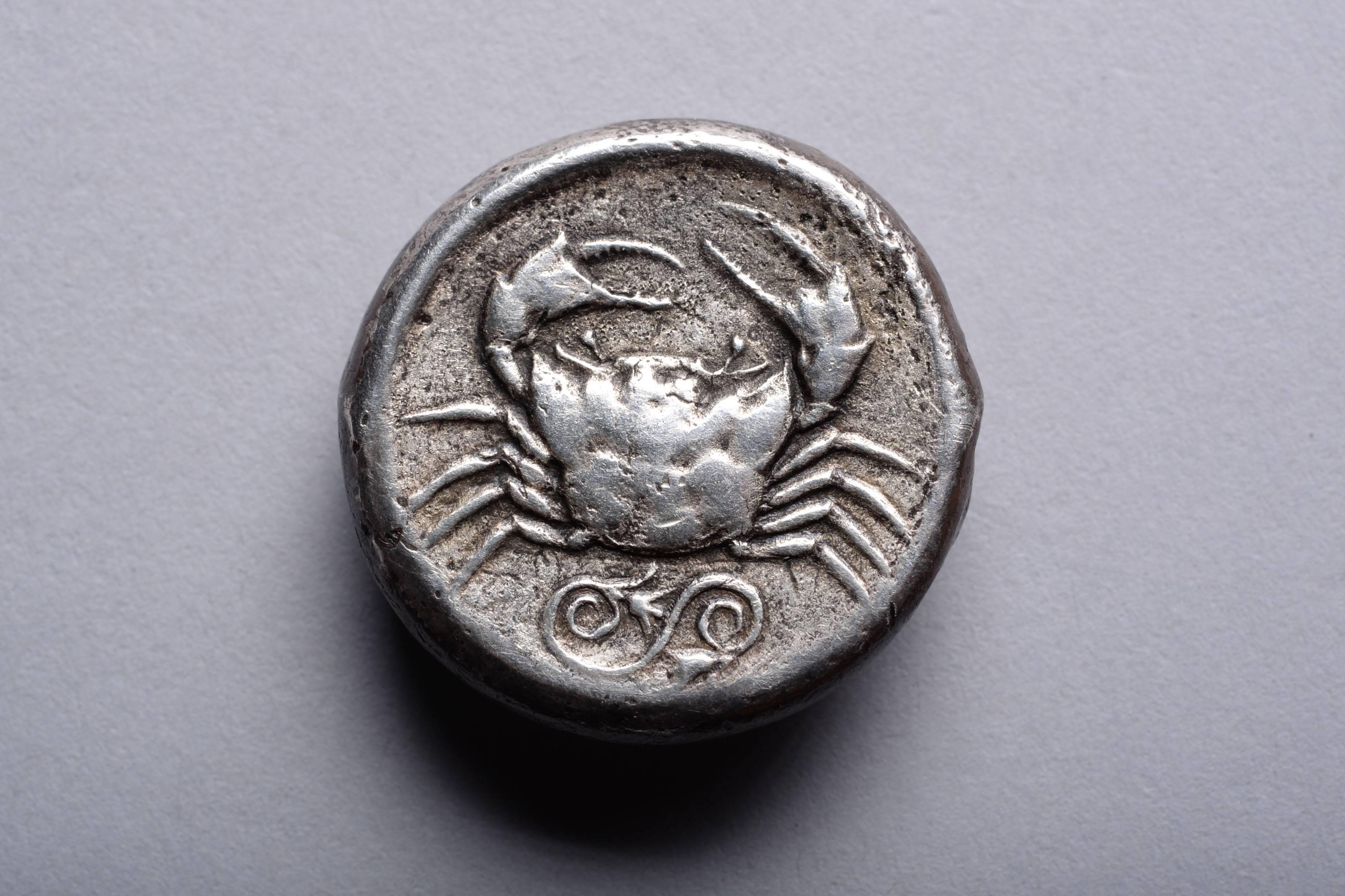 An ancient Greek silver tetradrachm coin from Akragas, Sicily. Minted, circa 460 - 446 BC.

The obverse with a sea eagle perching on top of an Ionic column. The Greek inscription reading:

AKRACANTOS

