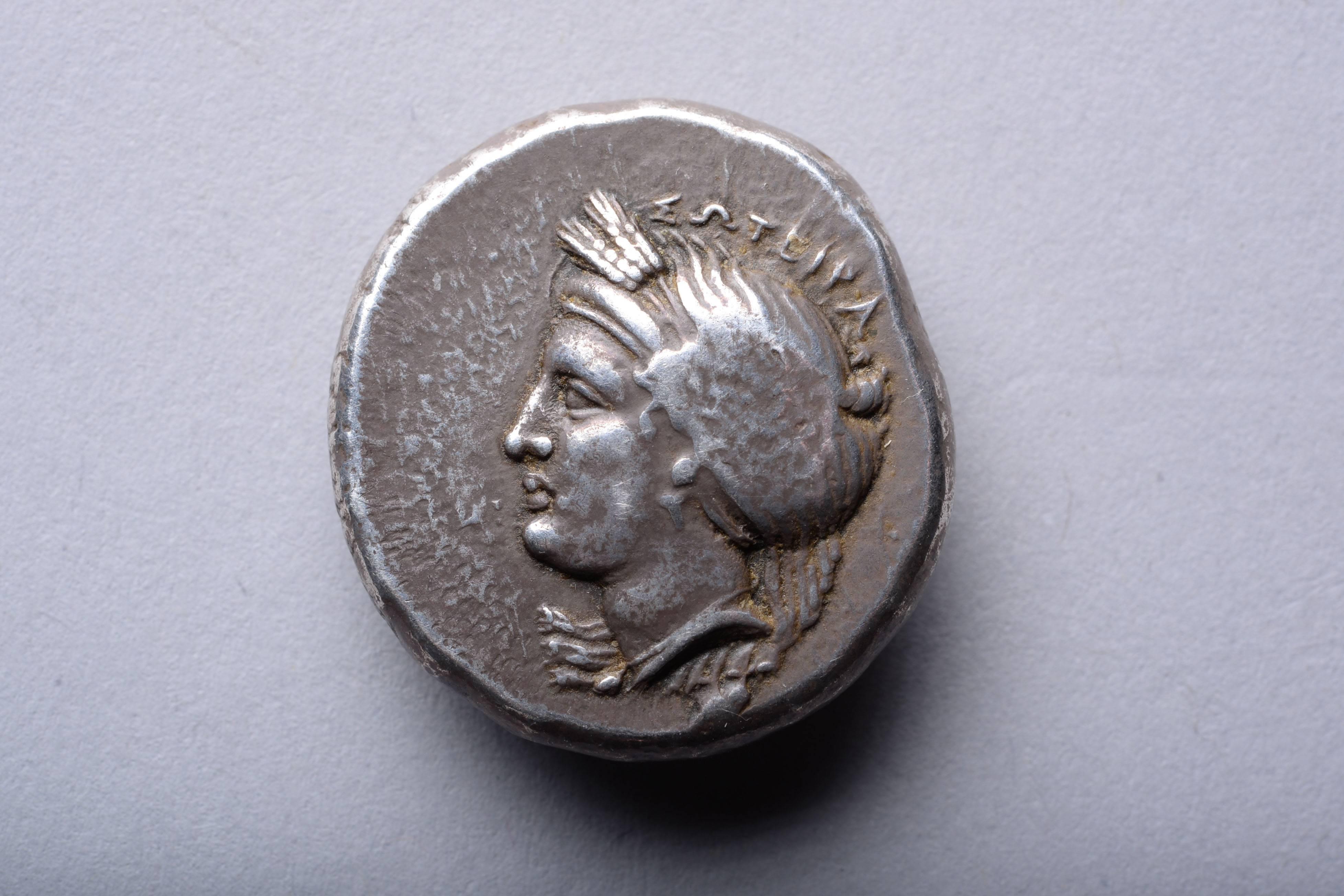 A silver tetradrachm from the city of Cyzicus, Mysia, modern-day western Turkey, circa 380-360 BC.

The obverse with the head of Kore-Soteira ('the Saviour Maiden'), her hair bound in a headband and wrapped in a wreath of barley ears. The