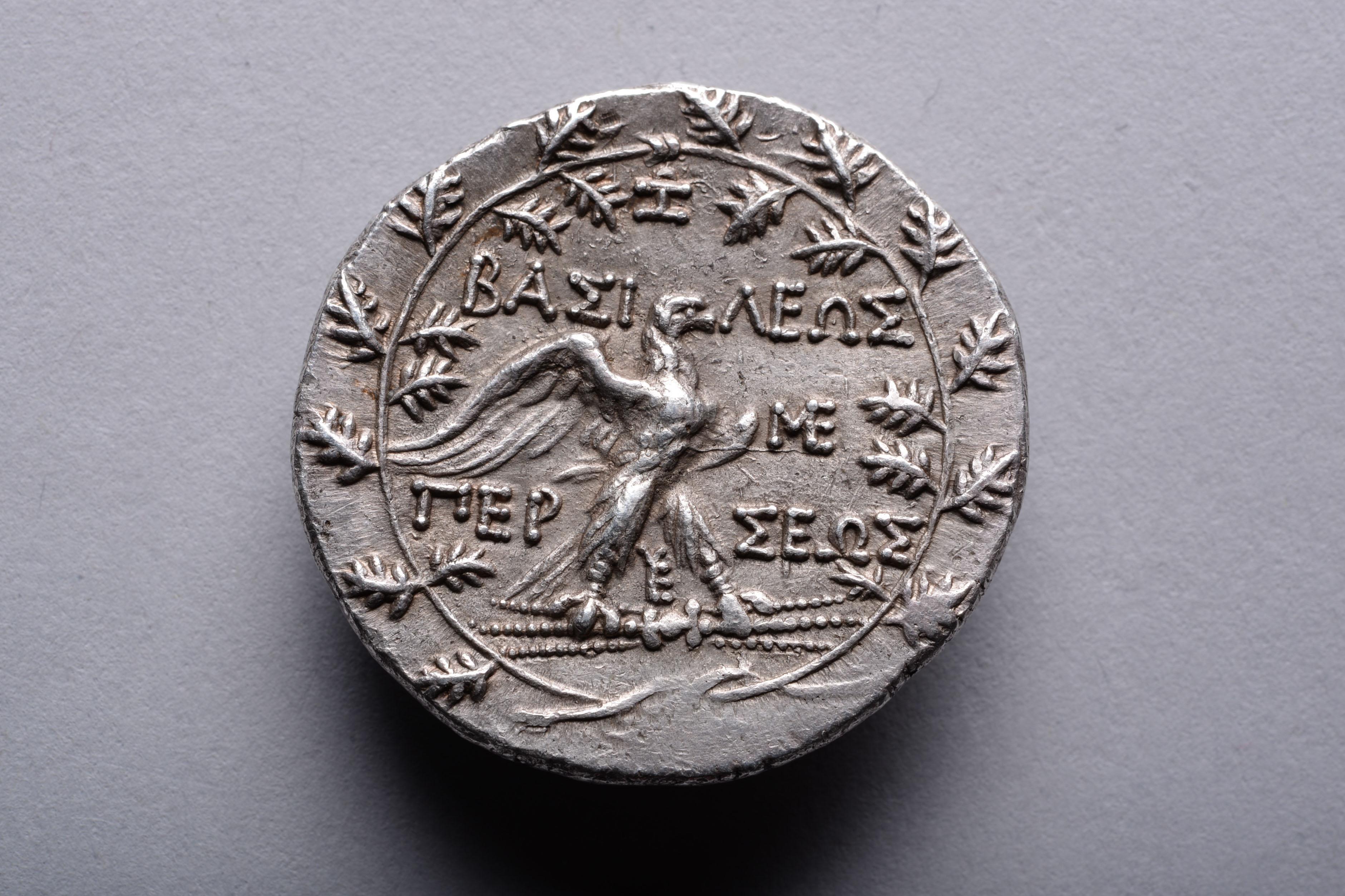 Silver tetradrachm minted under King Perseus of Macedon. Issued under magistrate Zoilos at the Pella or Amphipolis mint, circa 178-168 BC.

The obverse with the head of Perseus with short beard and furrowed brow, a diadem cutting through the rough