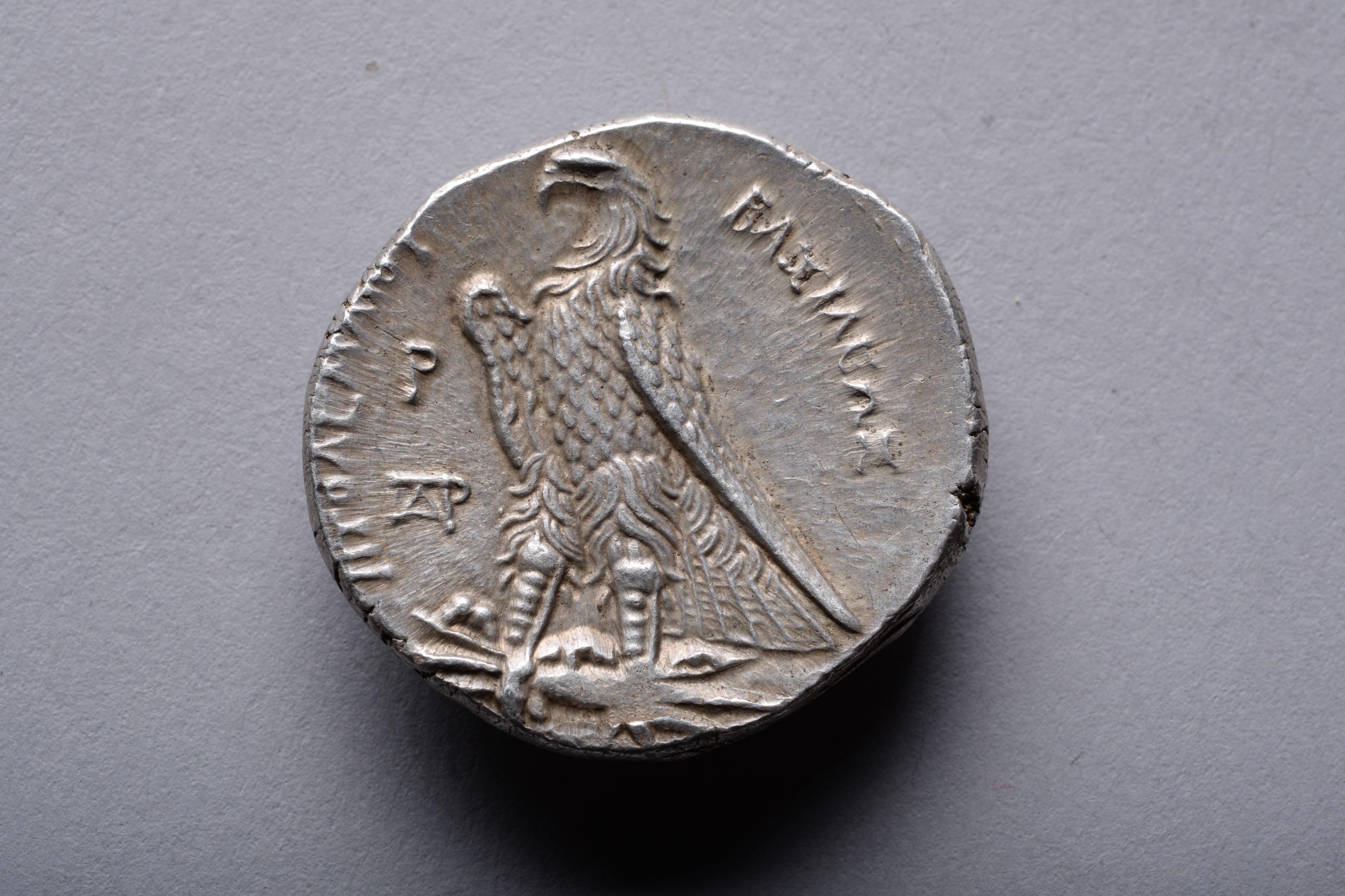 A silver tetradrachm issued by Ptolemy I Soter (Saviour), circa 300-285 BC, Alexandria mint.

The obverse with the head of Ptolemy, in bold Hellenistic style; the wild curls of his hair bursting out from under a royal diadem. Signed, behind the