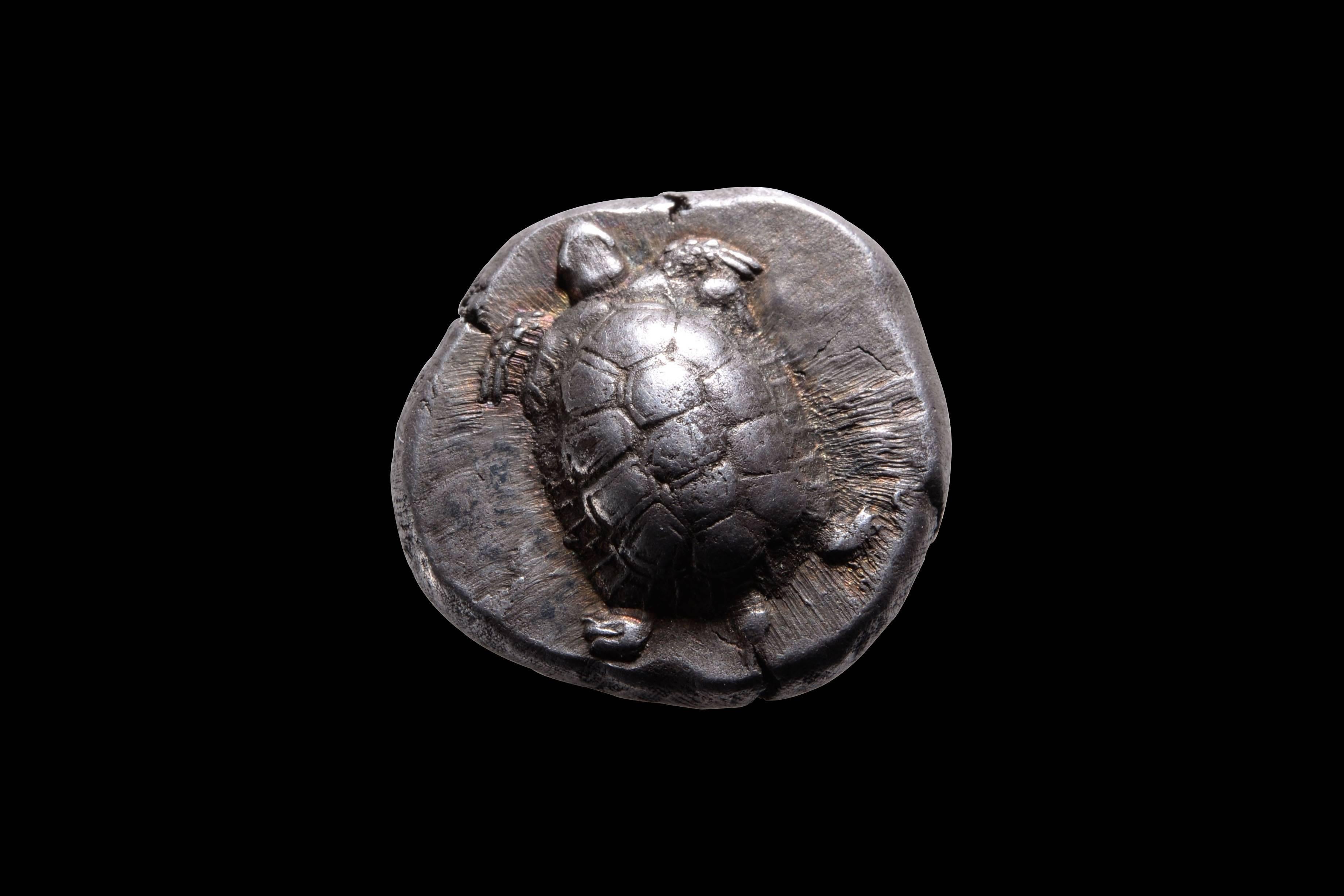 A charming ancient Greek silver stater from the island of Aegina, circa 456 - 431 BC.

The obverse with a tortoise, seen from above. The creature perfectly centred and preserved on a pleasing nugget of silver.

The reverse with an incuse square