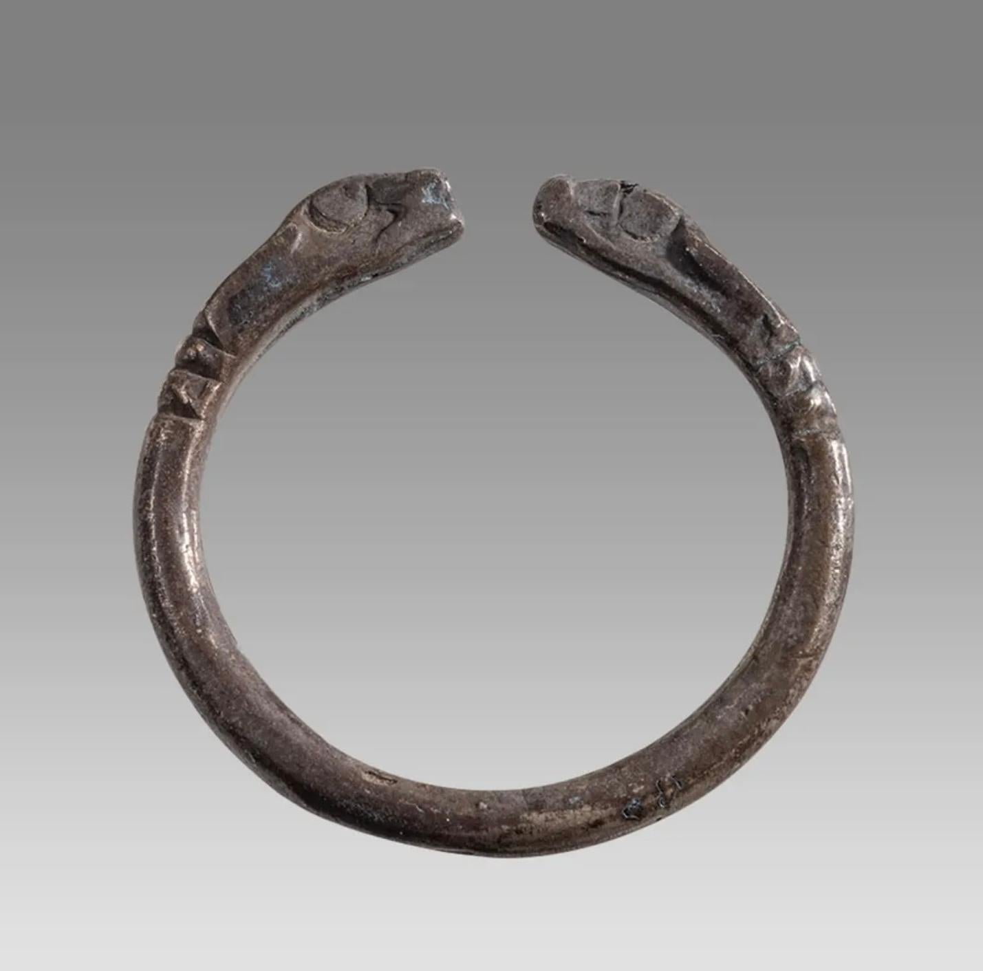 Embrace the elegance of Ancient Greece with this exquisite wearable Museum Quality Silver Snake Ring from the 4th century BC, featuring Snake Head terminals.  A Certificate of Authenticity is available. We see the form of snakes used to this day in