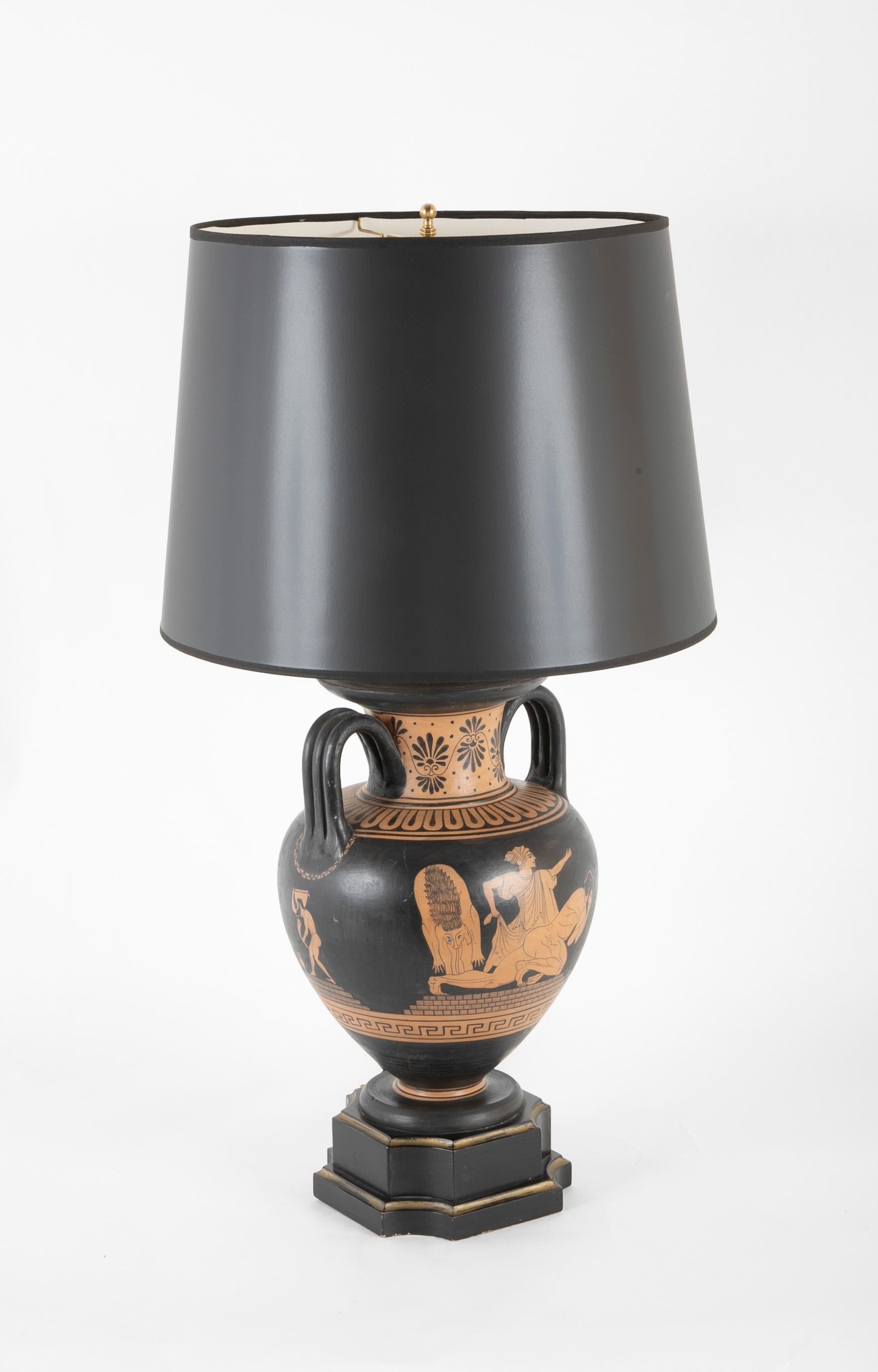 Red and black painted terracotta vase in the form of an ancient Greek krater now mounted on a black and giltwood base as a lamp. The urn form with two handles is decorated with a mythological scene from the Odyssey, with figures on all four sides. A