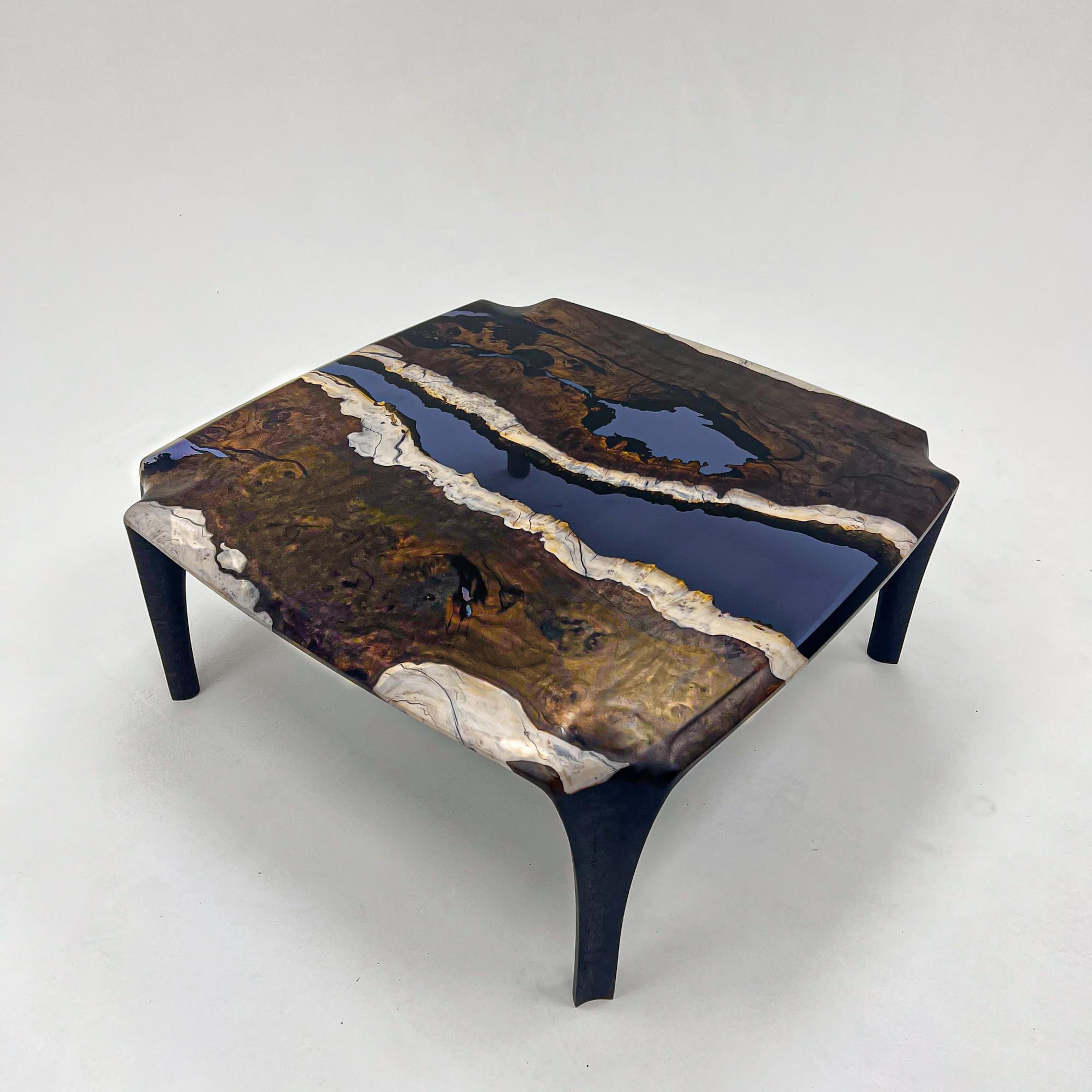 Epoxy Coffee Table

Handcrafted by skilled artisans of Tinella Team, this coffee table seamlessly fuses natural wood with smoke epoxy resin, creating a captivating piece that captures nature's beauty. 
Its exceptional design and craftsmanship make