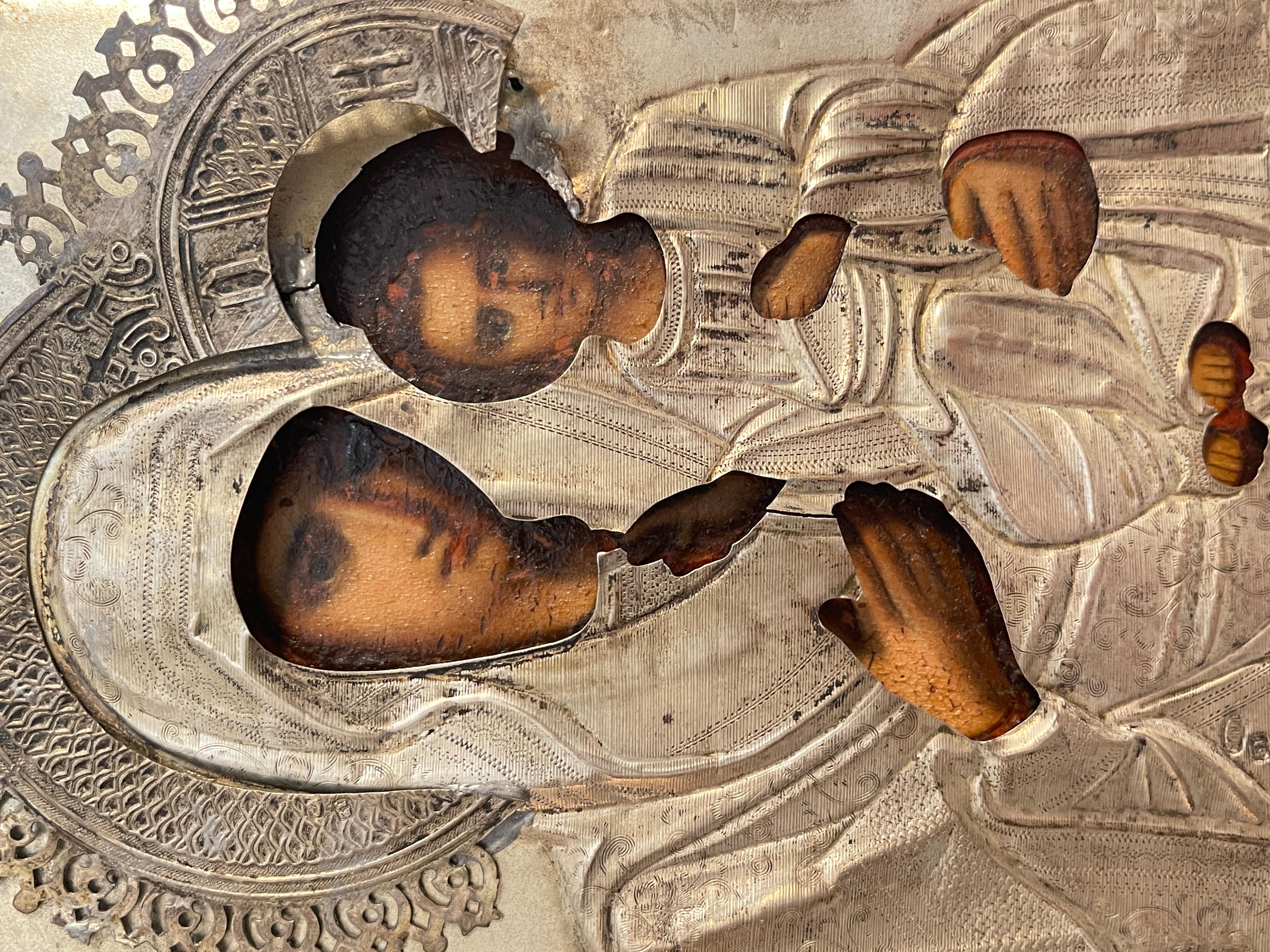 Ancient icon of fine workmanship, dating back to the 19th century, Russian. The icon represents the Madonna in the center with the Child, covered with silver riza.
In good condition, as shown in the photos, some defects and signs of wear due to