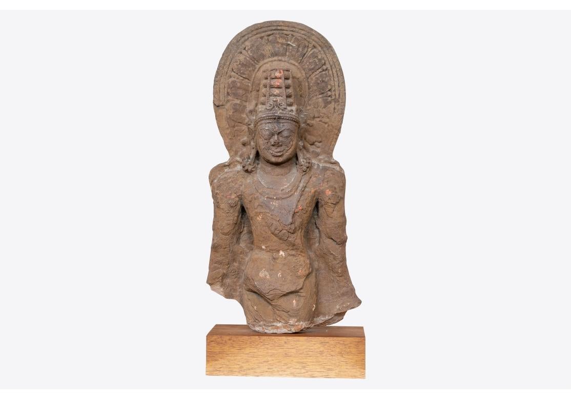 Exceptional Antique Carved Stone Bust of Vishnu  Mounted On a Wooden Base. Ca. 7th-12th Century AD. An ancient carved stone sculpture  depicting Vishnu, wearing drapery and his characteristic conical headdress. The fragmentary carved stone figure is
