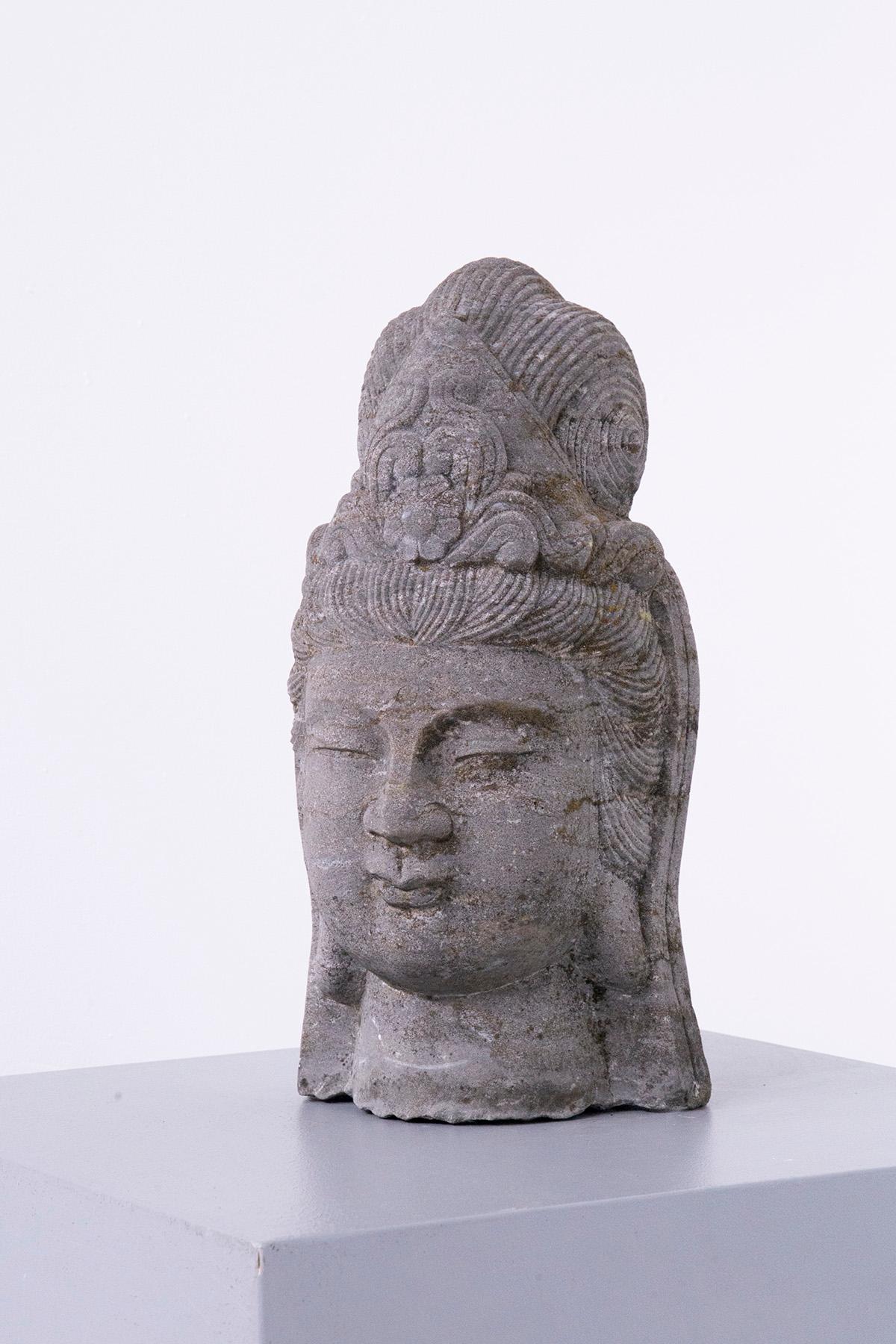 The lava stone Buddha head sculpture, which came from India in the early 1900s, is a remarkable work of art that encapsulates the rich cultural and artistic heritage of the region. Carved in stone, this sculpture represents a significant aspect of