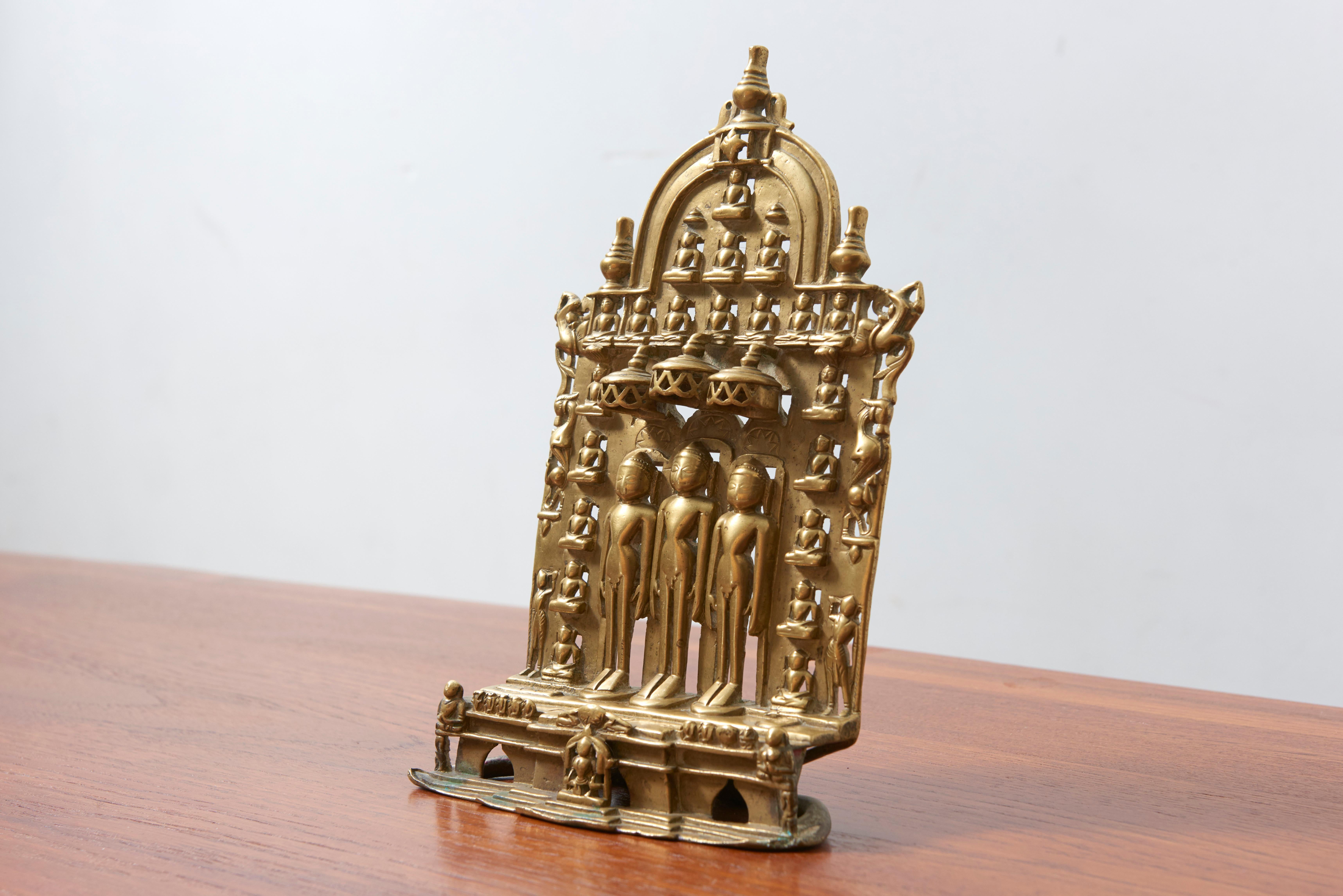 An authentic, ancient and exceptional Three Jina Shrine. For it’s age the altarpiece is in a very good condition and rather large. The image of three standing, nude Jinas flanked by the other 21 seated Jinas is rare. The lintel of the shrine is