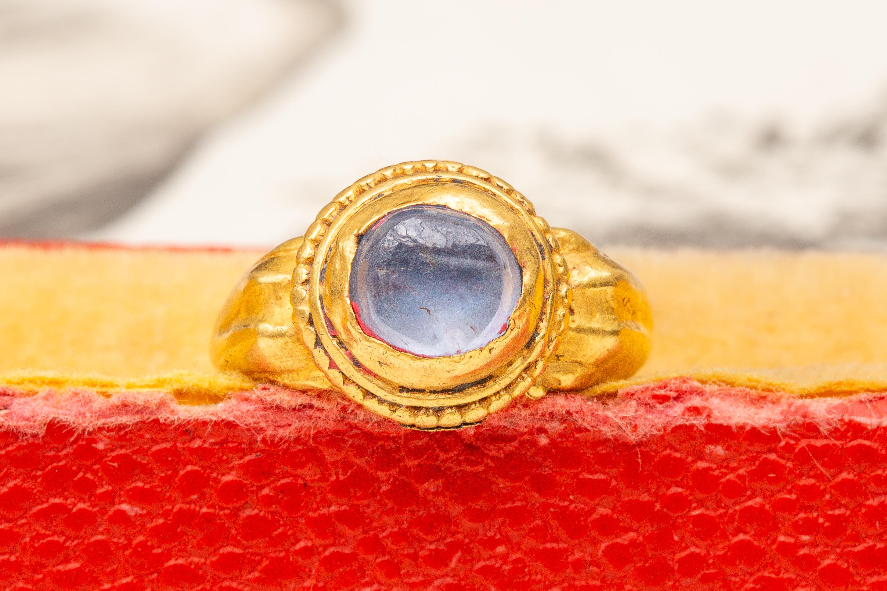 A scarce ancient Javanese gold and sapphire ring dating from the 7th-15th century Indonesian Classical period. 

As expected with Javanese gem-set gold rings made in this period, the present ring is crafted with folded sheets of high-karat gold and
