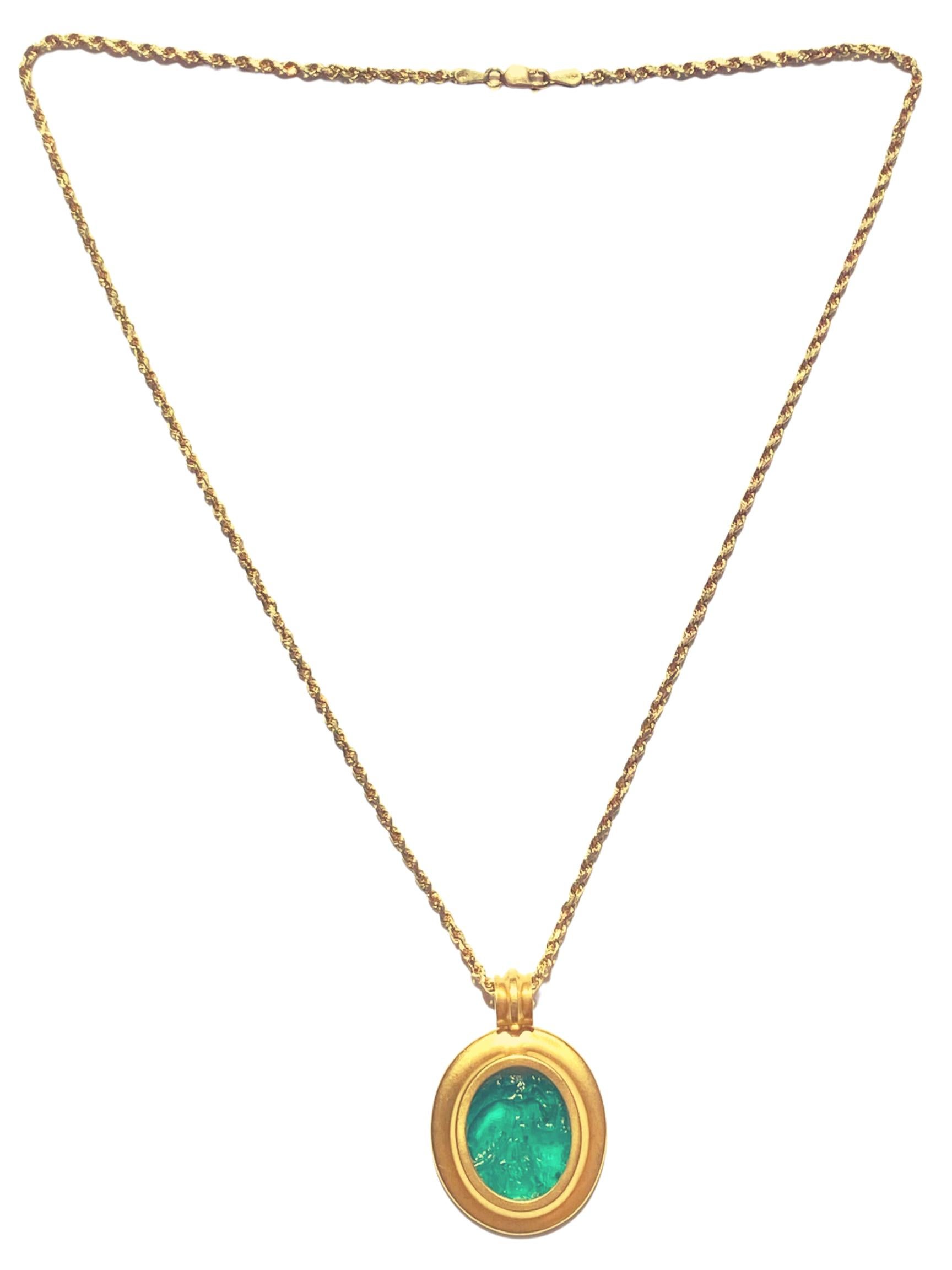 A 2000 BC–1000 BC Era Ancient Egyptian Blue Glass Carving Necklace mounted on 14K Yellow Gold.
The 32.5x25mm Blue Glass piece has a depiction of the Ancient Egyptian God 