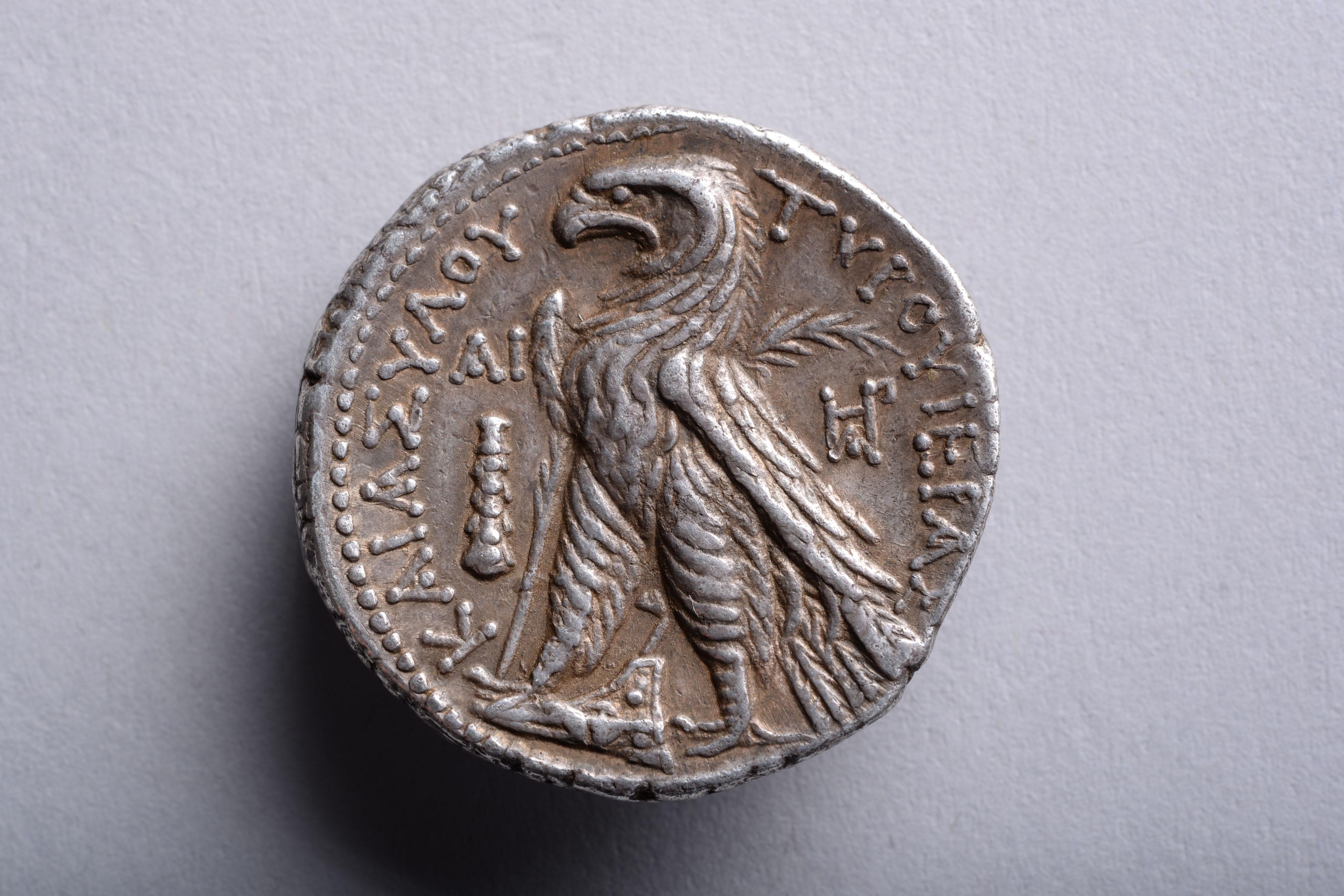 A silver shekel from the city of Tyre, minted in year 11 of the Tyrian calendar, 116-115 BC.

The obverse with the portrait of the God Melqart, chief deity of Tyre, wearing a laurel wreath.

The reverse with an eagle, standing on a ship’s prow, with