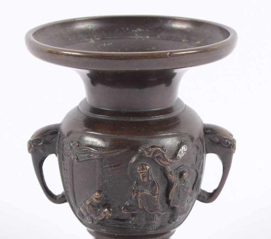 This Meiji ceremony vase is a browned bronze plate vase, realized in Japan under the Meiji Empire (1867-1912).

Beautifully decorated with a relied decor representing a Japanese religious ceremony on the round-body of the vase, and white