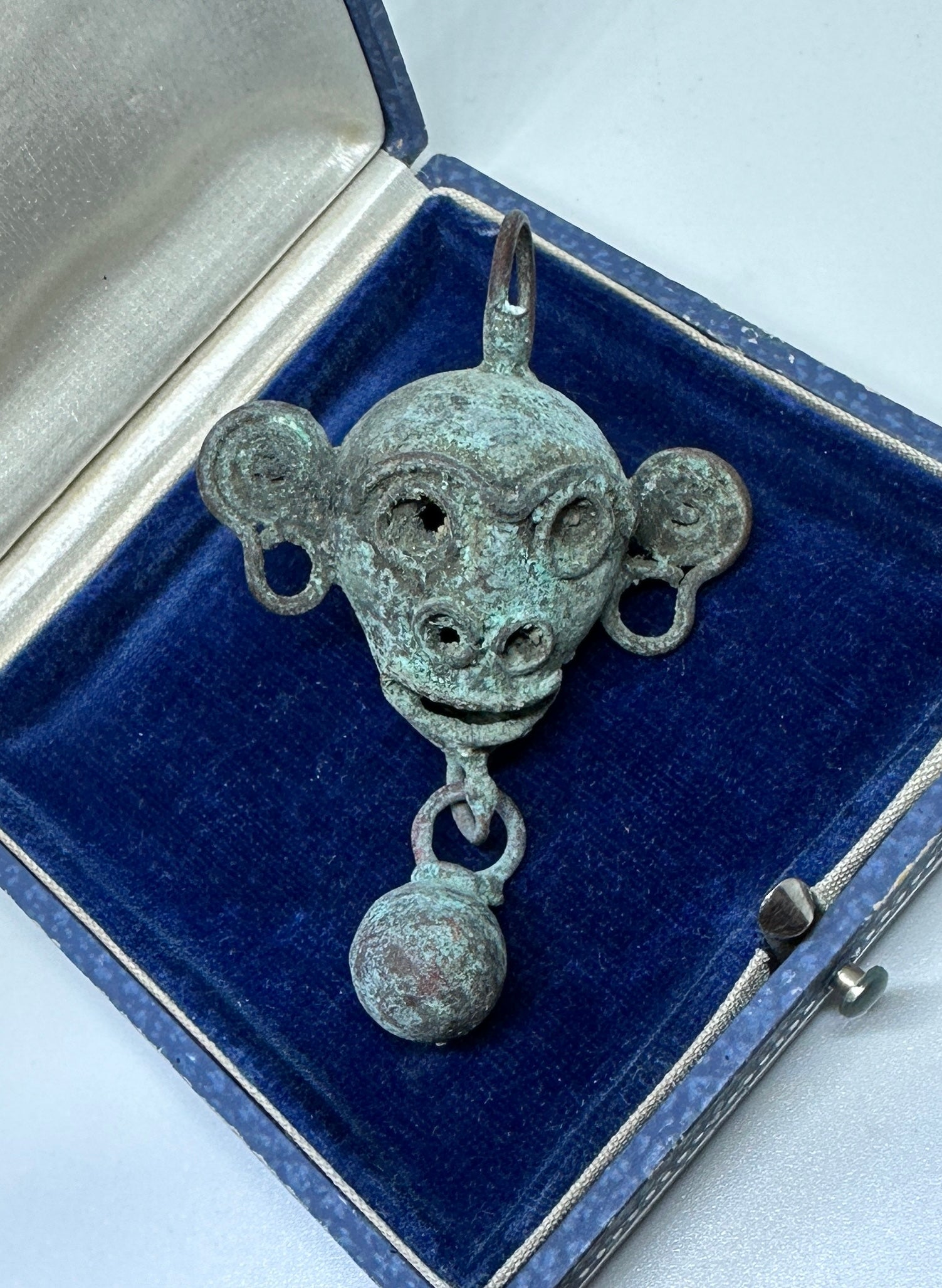 Unveil the elegance of antiquity with this fantastic copper bell pendant cast as the head of a monkey with applied wire facial features from Latin American, Mexico, Mixtec culture, Post-Conquest period, circa mid-16th century.   The finely crafted