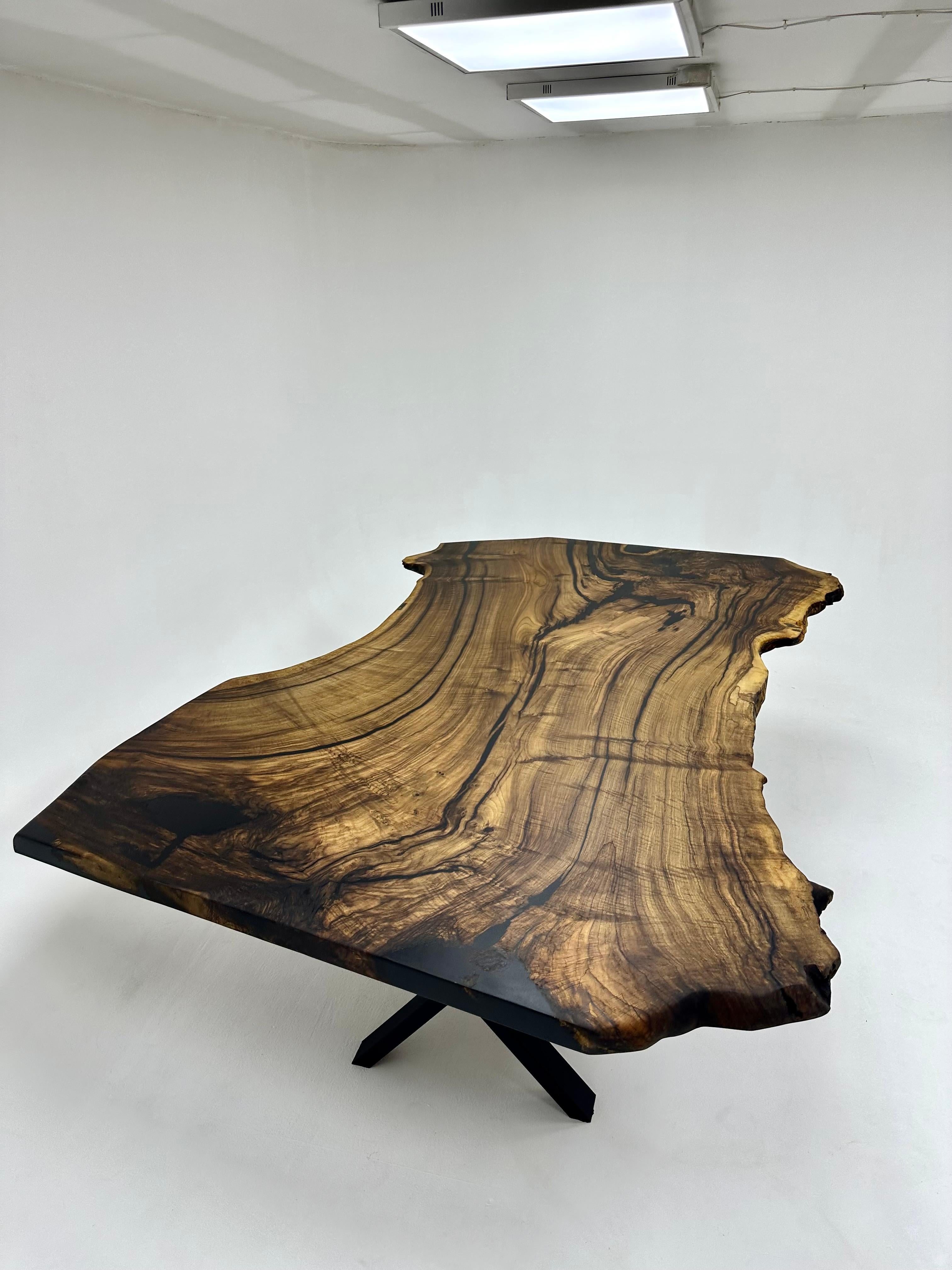 LIVE EDGE WALNUT CONFERENCE TABLE

This table is made of natural walnut slabs. 

Some Walnut slabs have a lot of natural beauty as it’s one side has a large curve. This is one of them! 

We've filled the cracks with black epoxy, without disrupting
