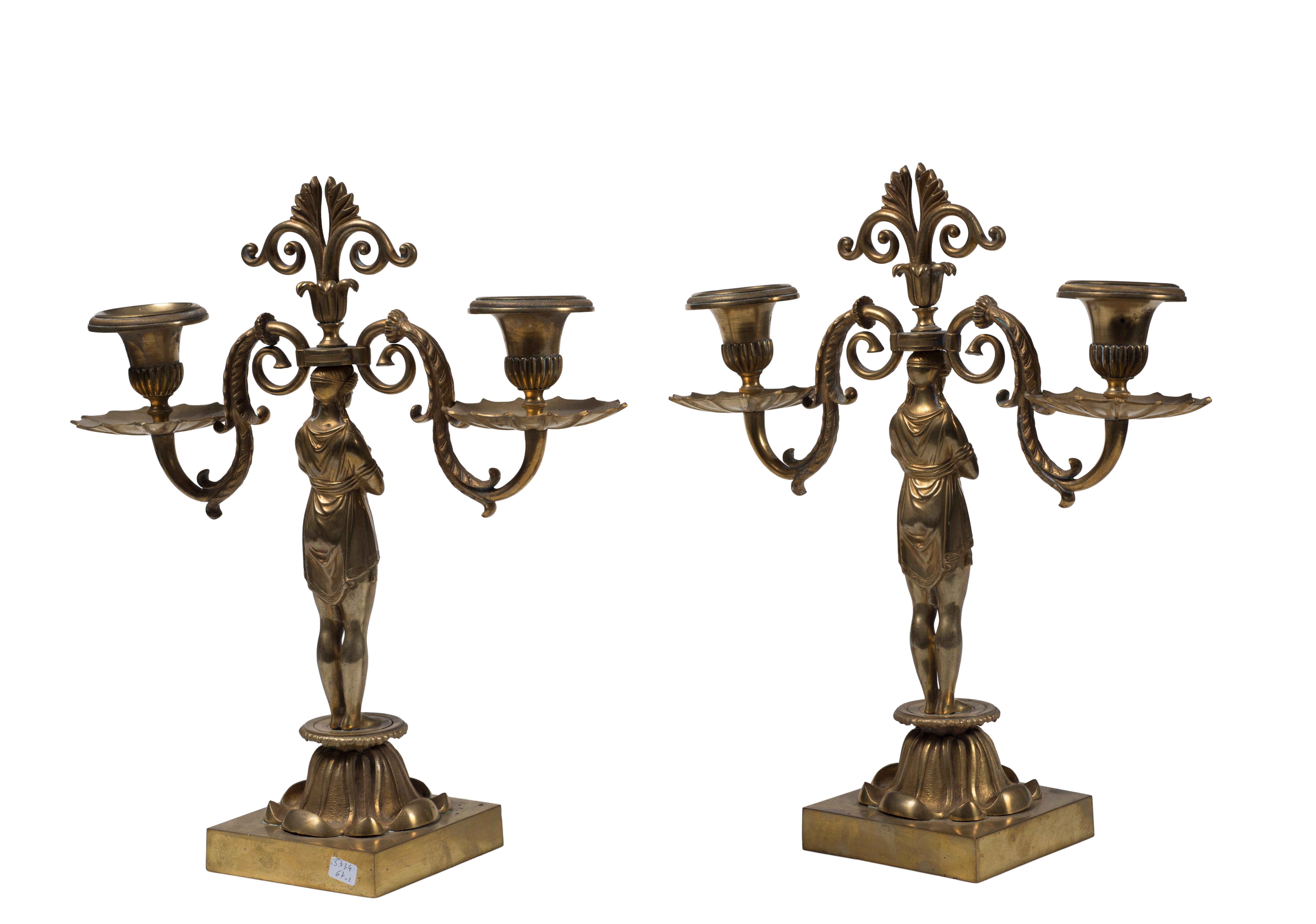 Pair of candleholder is an original decorative object realized at the end of the 19th century by French manufacture.

The artwork has two arms in gilded bronze with a capital base surmounted by a sculpture of a female figure that supports the