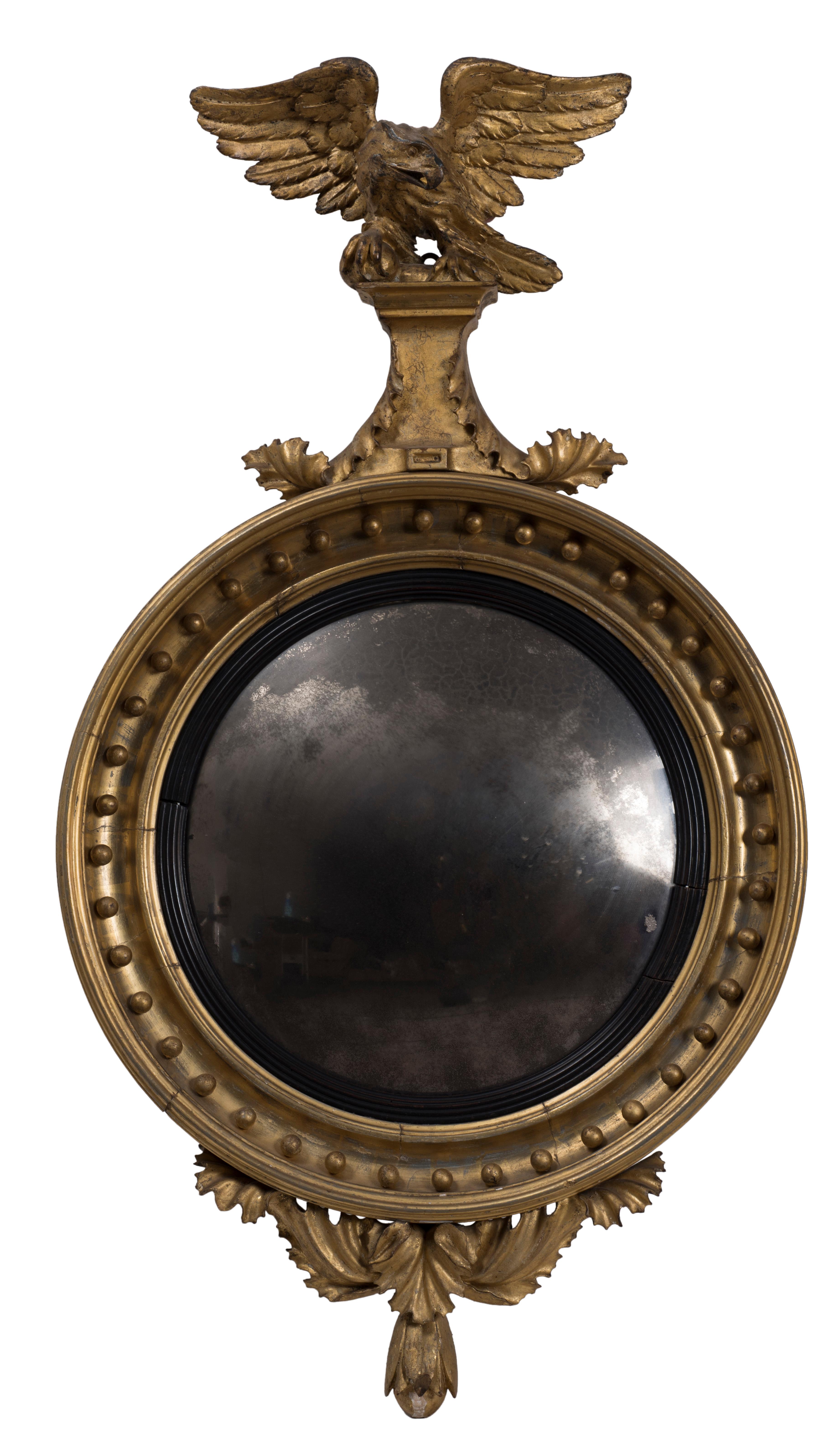 This Regency era wall mirror is a very elegant gilded wooden wall mirror. It was realized during the famous Regency era, noticed for its elegance and achievements in fine arts and architecture.

A majestic eagle surmounts the mirror.

Loss of