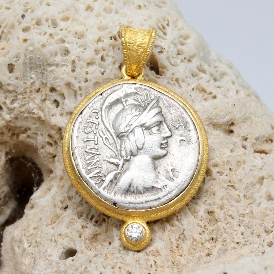 A sharply stuck, authentic, silver denarius coin from the Roman Republic 67 BC depicts the draped and helmeted bust of the Sabine goddess Vacuna.  The Sabines were an ancient tribe of peoples living primarily in the Apennine mountains who were