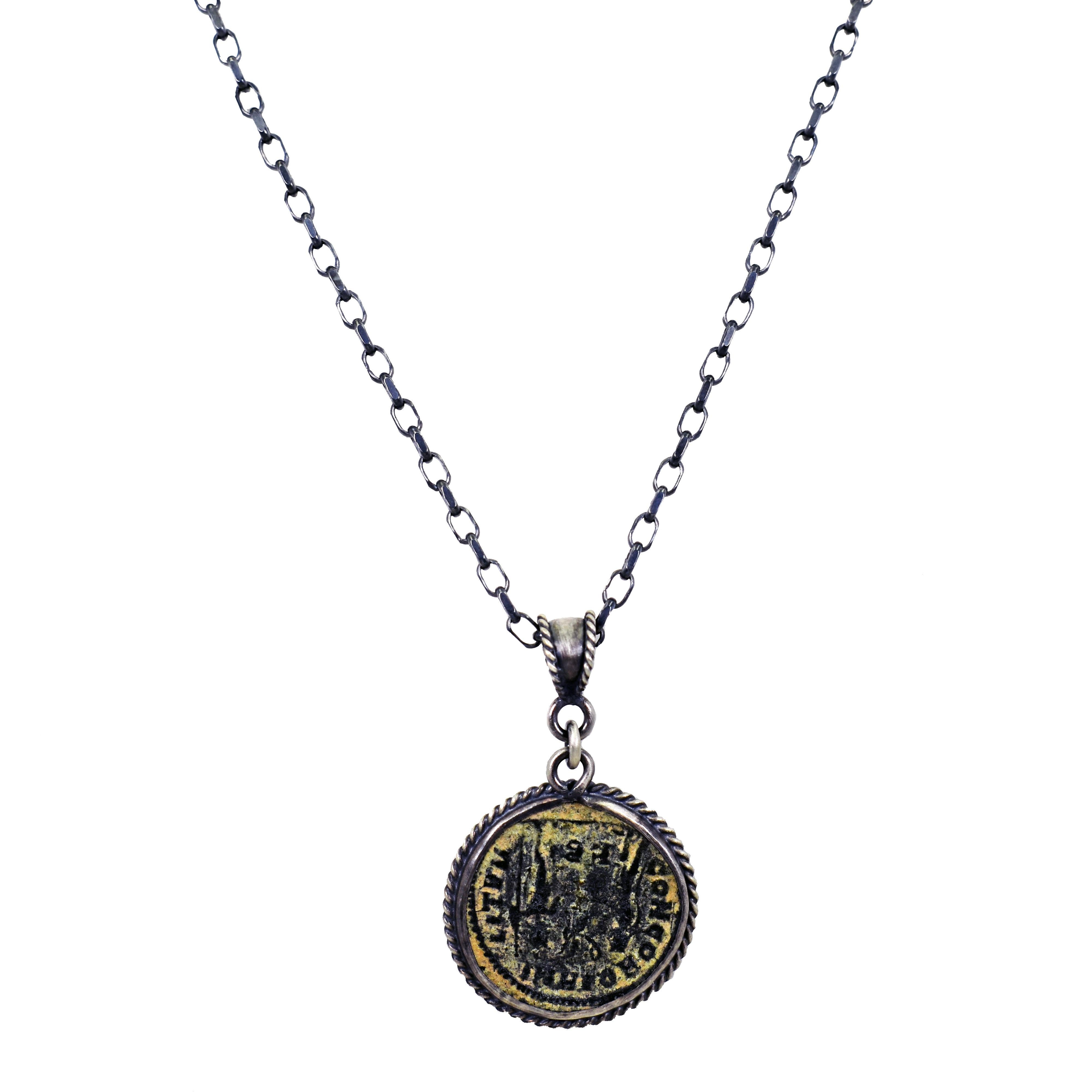 Authentic ancient Roman bronze coin (AE Antoninianus of Aurelian, 270-275 AD) oxidized sterling silver pendant with rope detail on 18 inch sterling silver cable chain necklace. Pendant, including bail, is 1.50 inch in length. Bronze coin is
