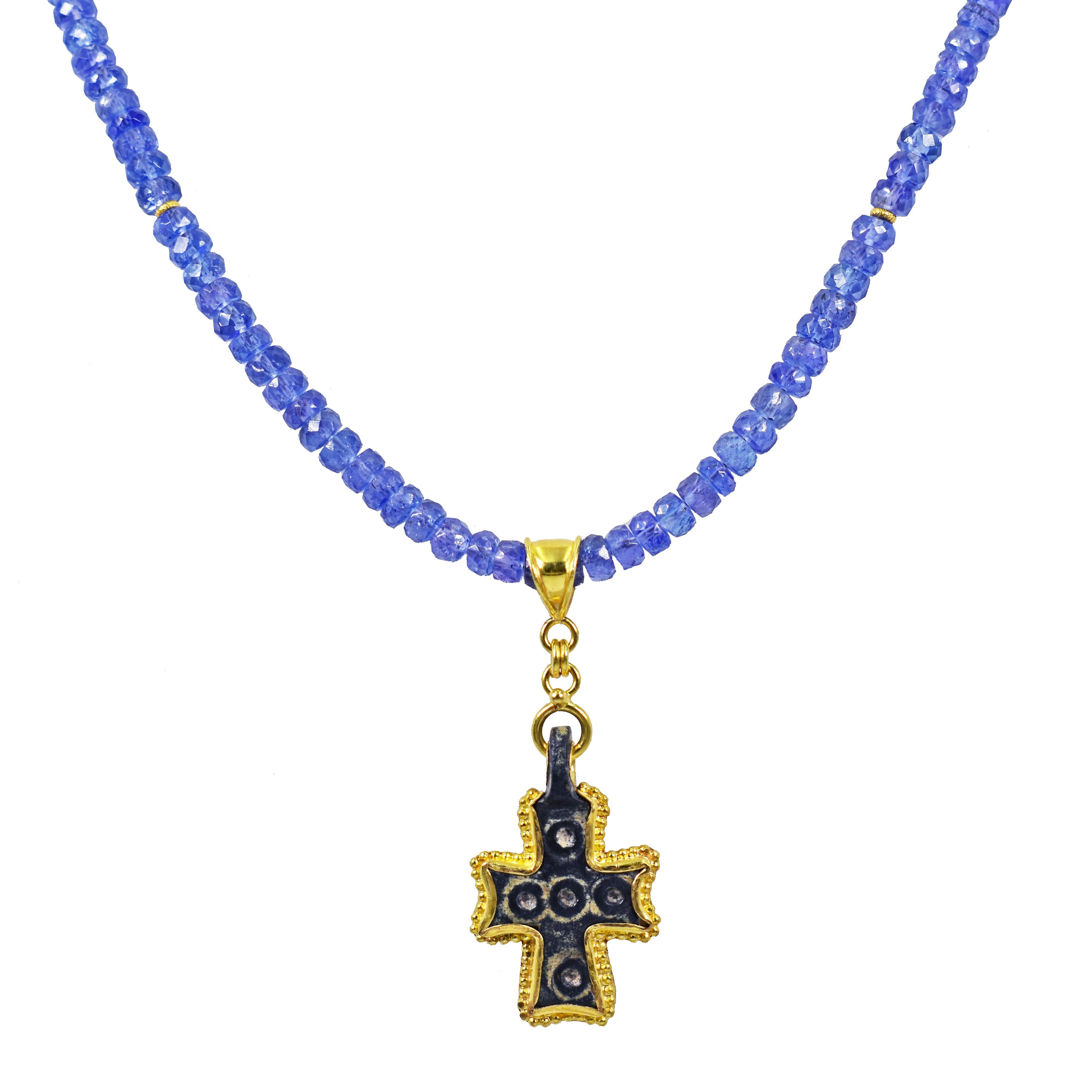 Authentic ancient Byzantine Era Roman bronze cross pendant with contemporary added 22k yellow gold details on a beaded necklace featuring faceted Tanzanite and accent 22k gold spacer beads. Necklace is 23.5 inches in length, and is finished with a