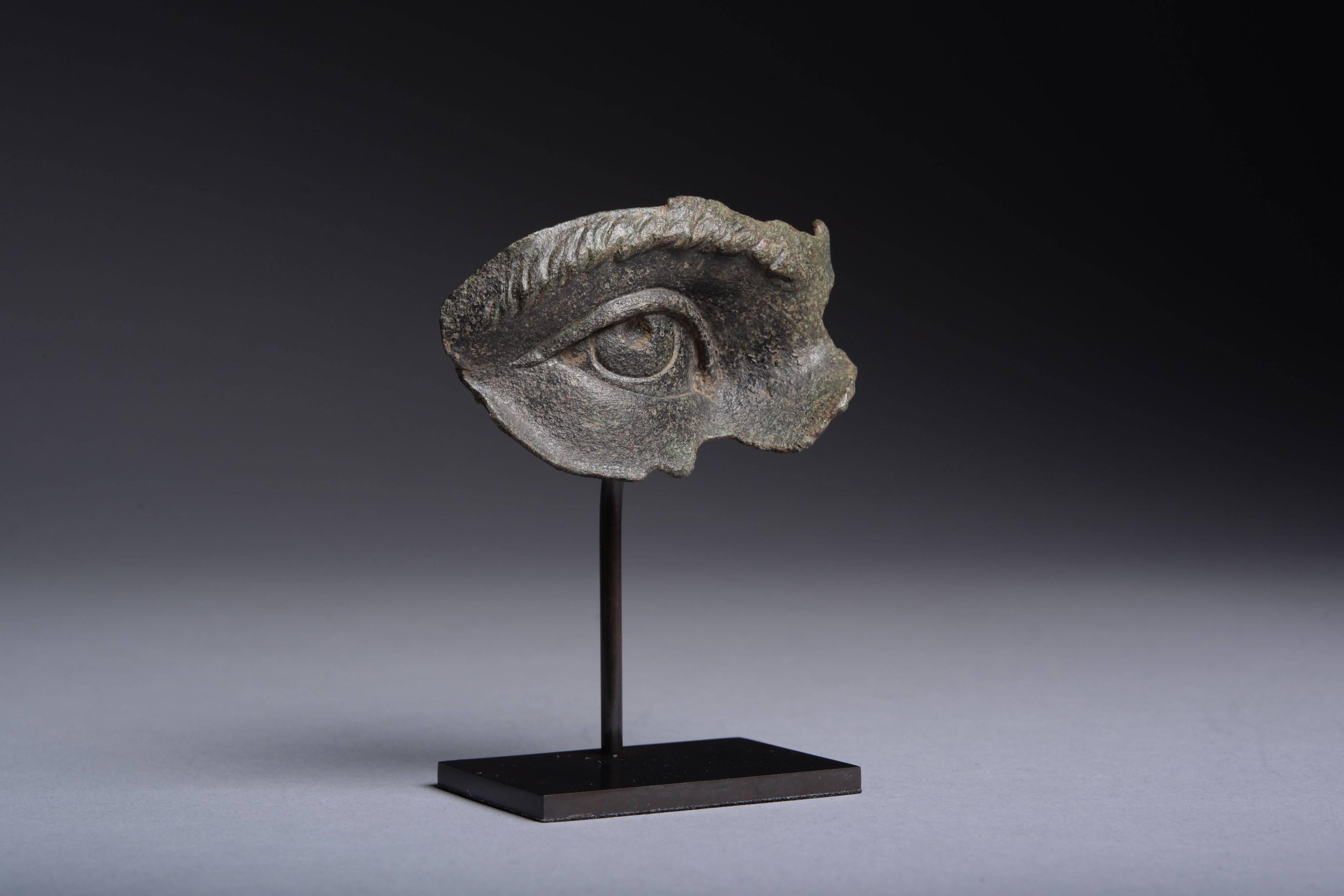 A fragment from a lifesize Roman bronze statue, dating to the 2nd-3rd century AD.

Finely modelled with deep set eye, heavy lids and large pupil, framed by a sweeping brow.

For a more complete fragment of similar style, depicting Emperor Marcus