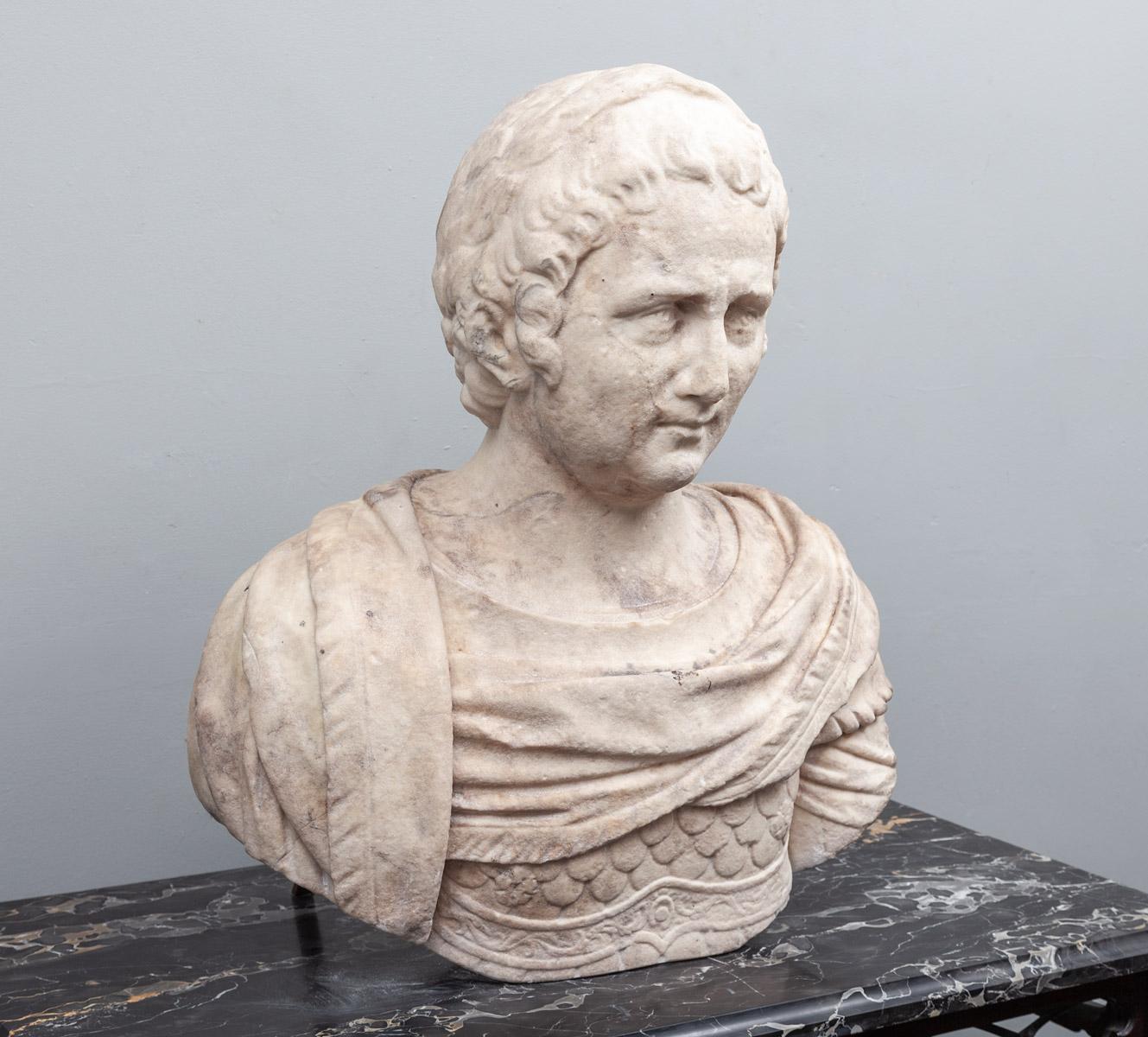 An ancient Roman marble bust of a male, dating to the 1st-2nd century AD.

Larger than life-size and depicting a male wearing a laurel wreath and military uniform, including body armour.

 