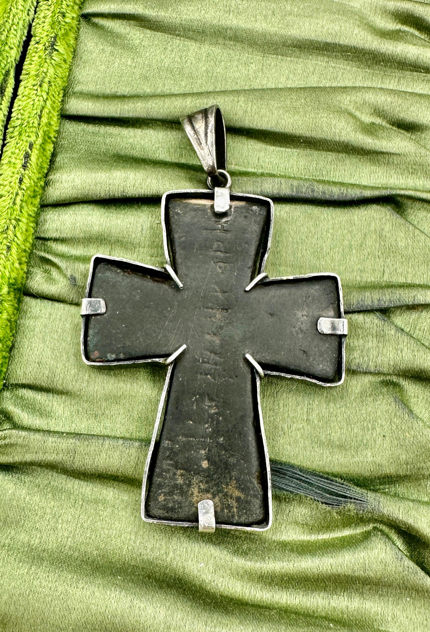 Indulge in a magnificent Museum Quality Ancient Roman Byzantine Bronze Cross dating to circa the eighth century AD.   The extremely fine bronze cross depicts Helena holding holy water in her right hand, the reverse side is inscribed with a line of